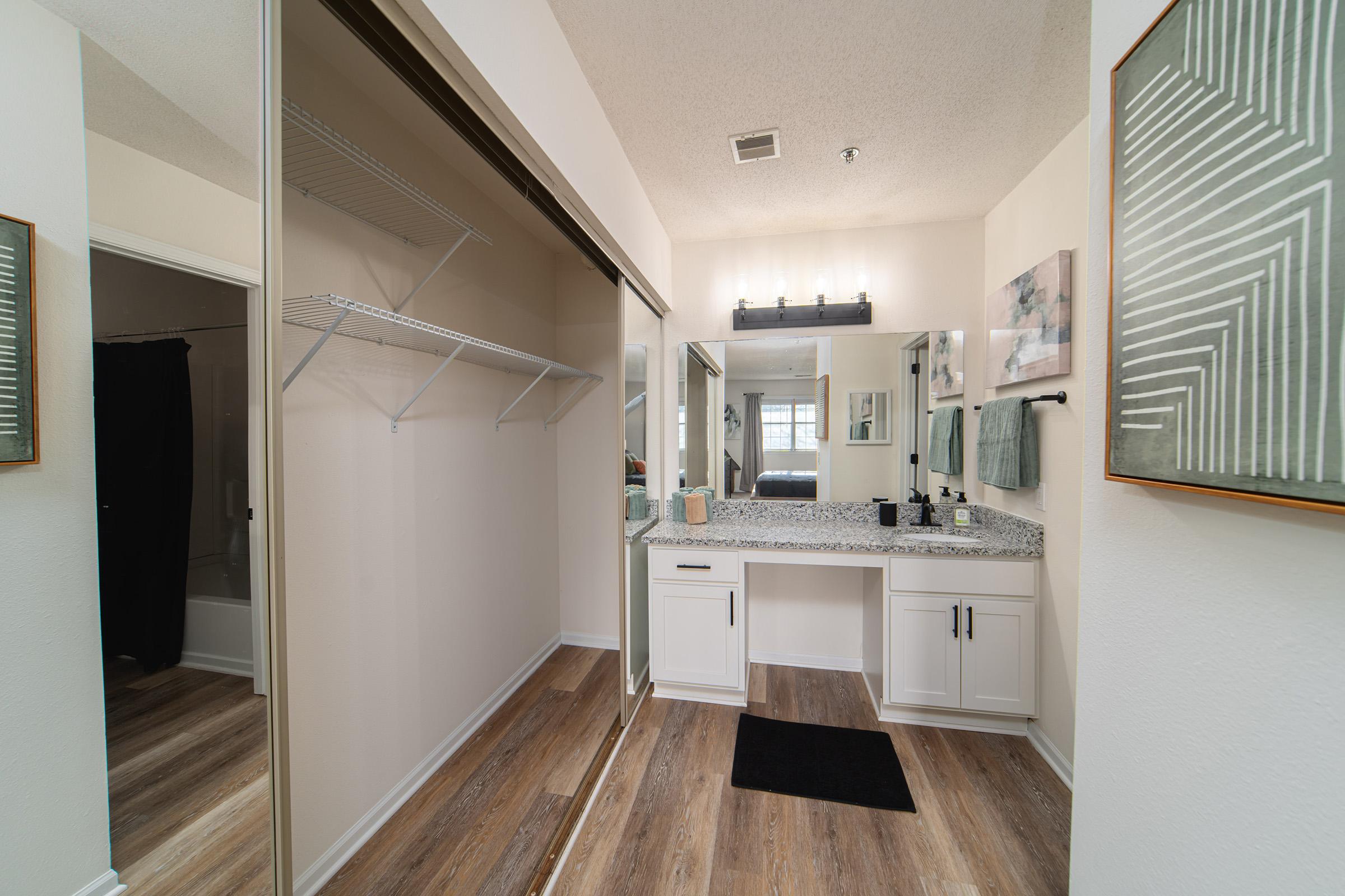 a kitchen with a sink and a mirror