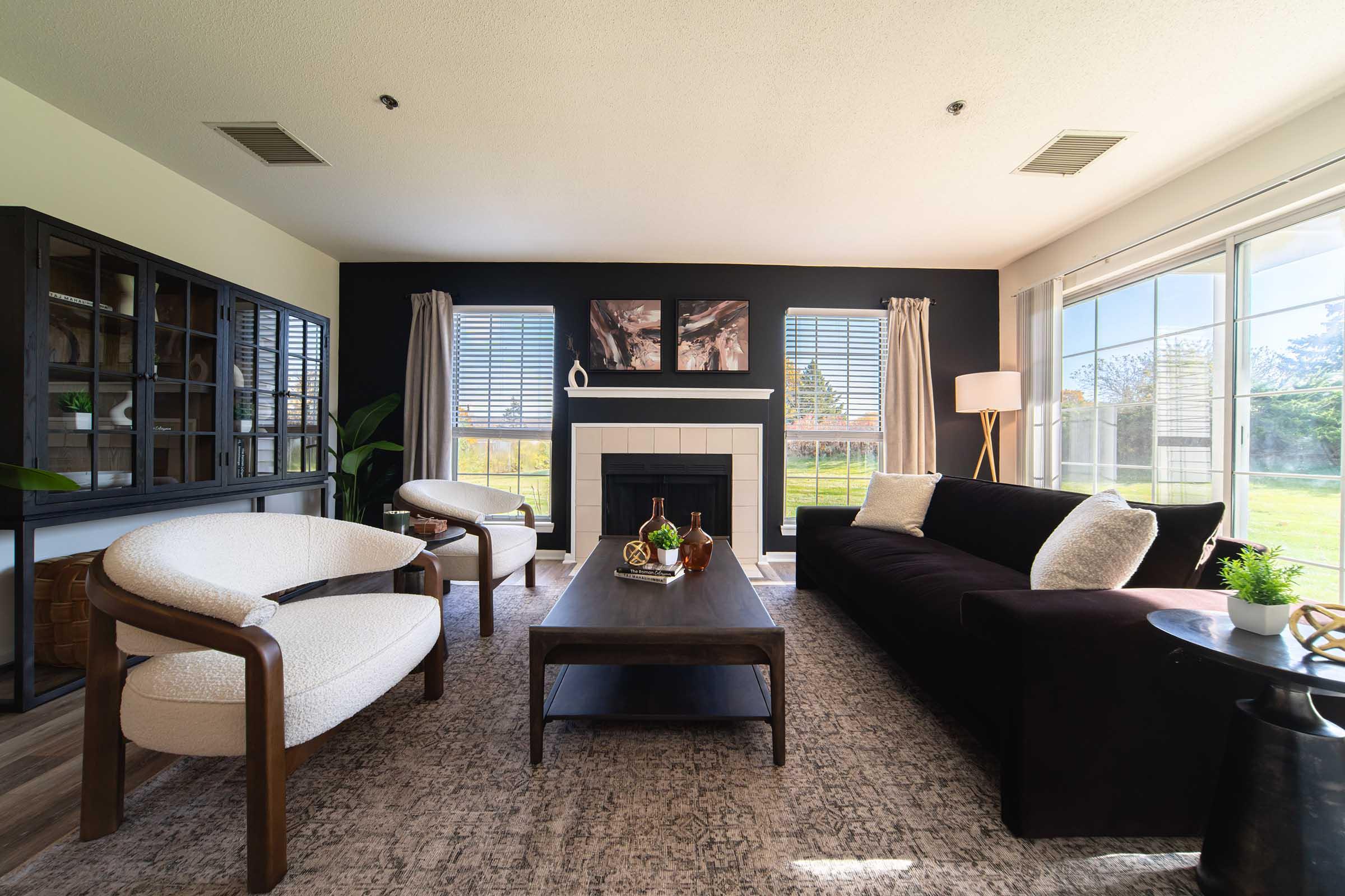 a living room filled with furniture and a large window