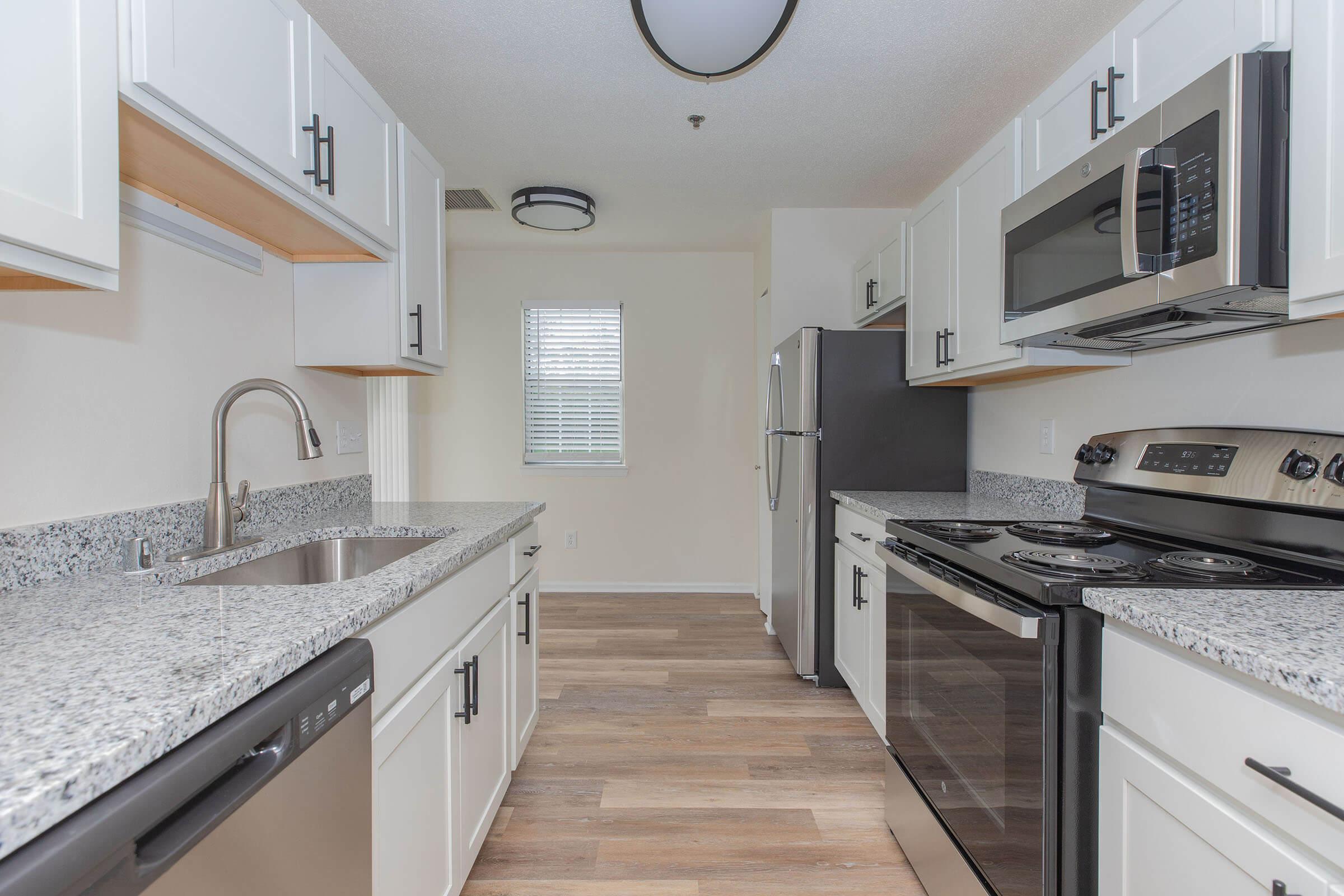 a kitchen with a stove a sink and a microwave