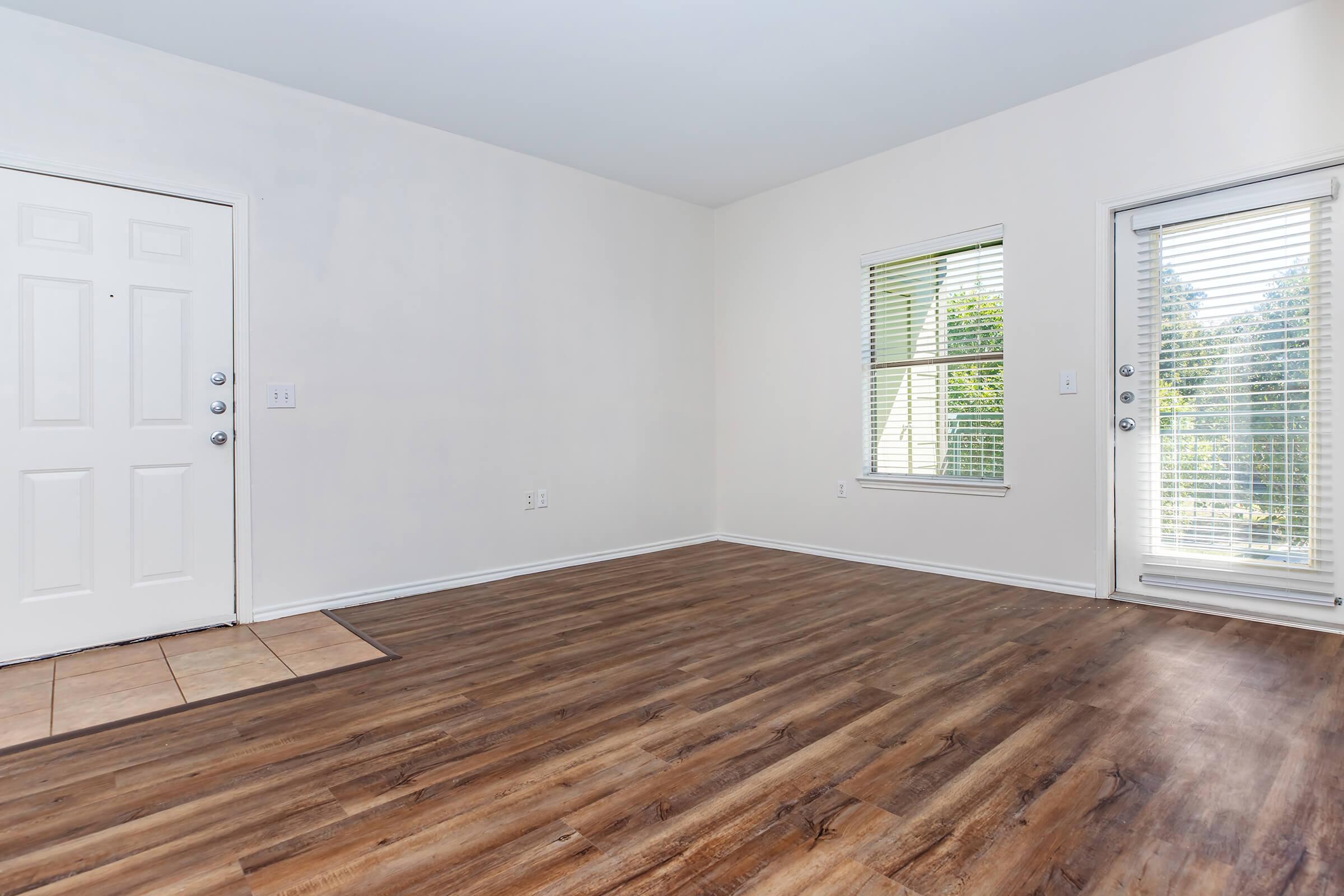 a large empty room with a wooden floor