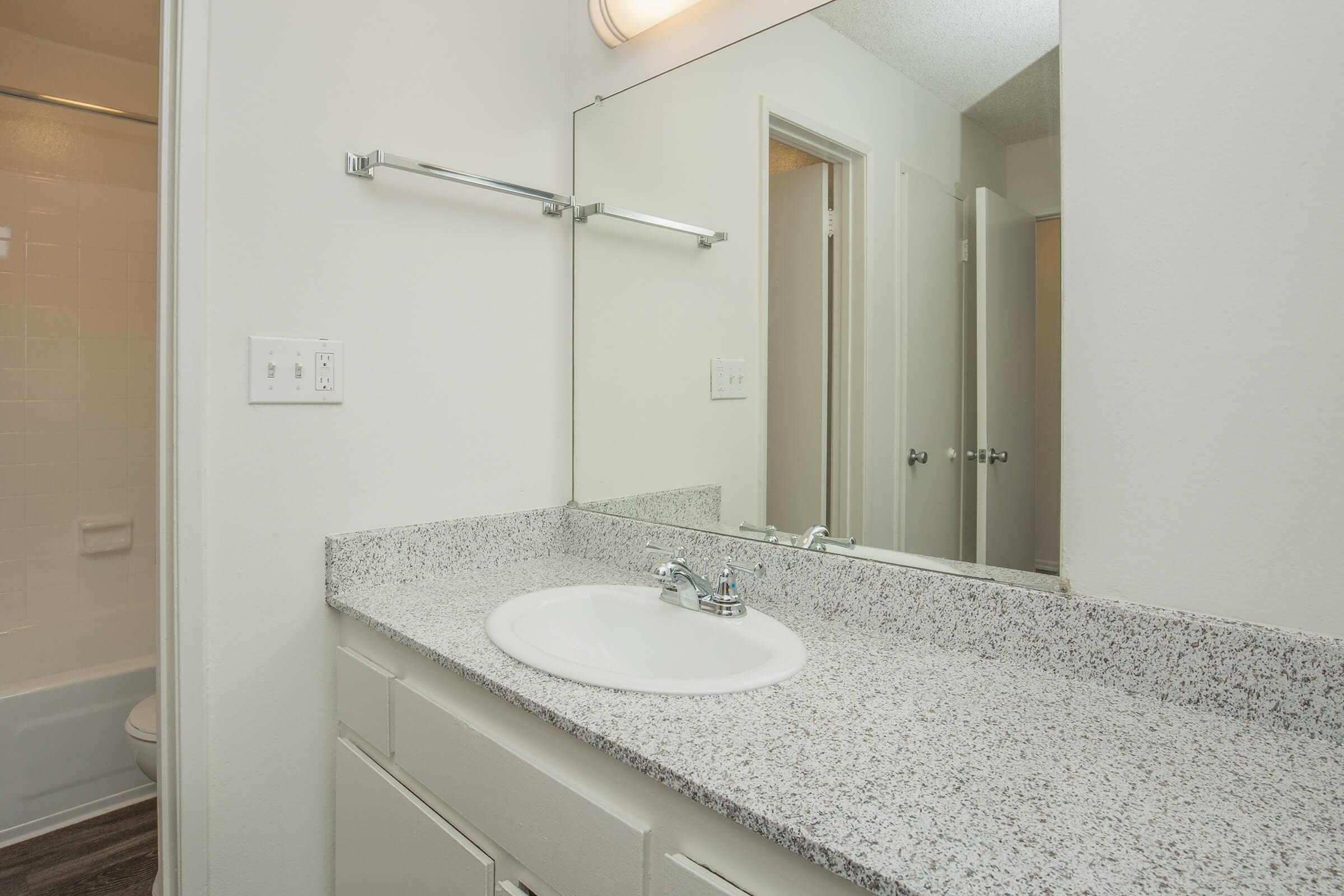 Bathroom sink with white cabinets