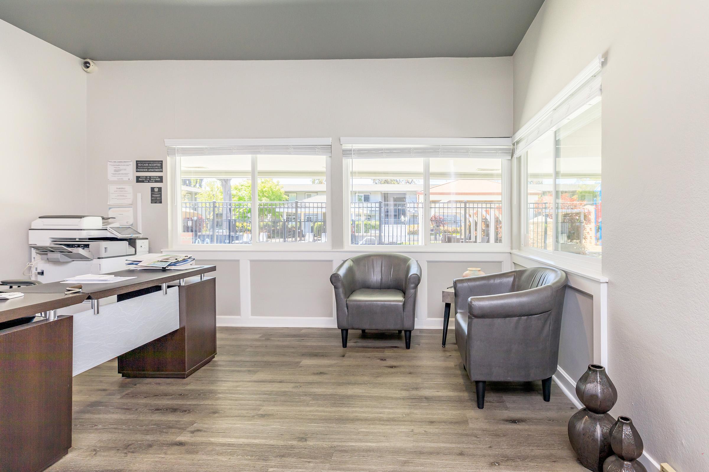 a room filled with furniture and a large window