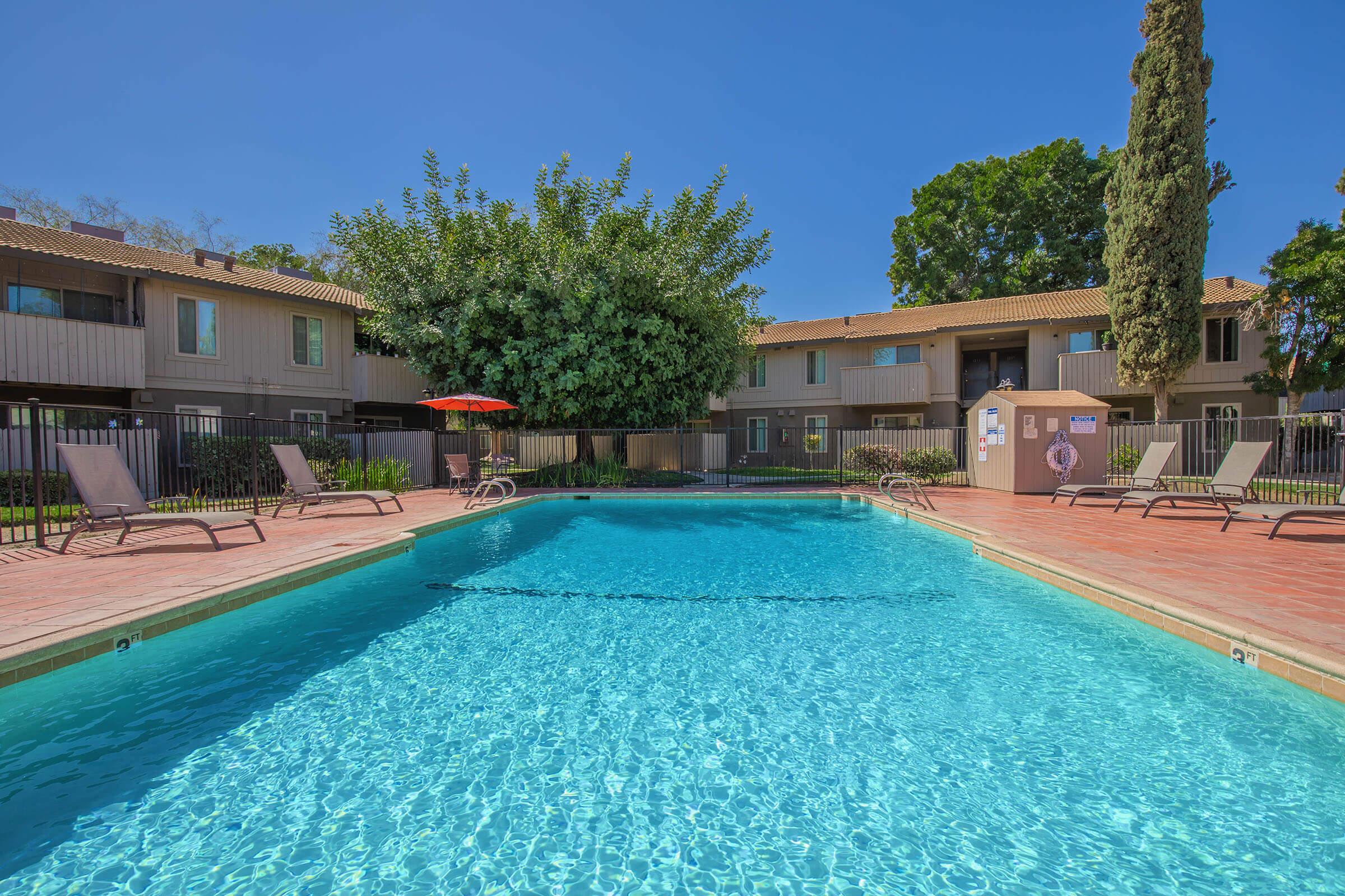 a house with a pool outside of a building