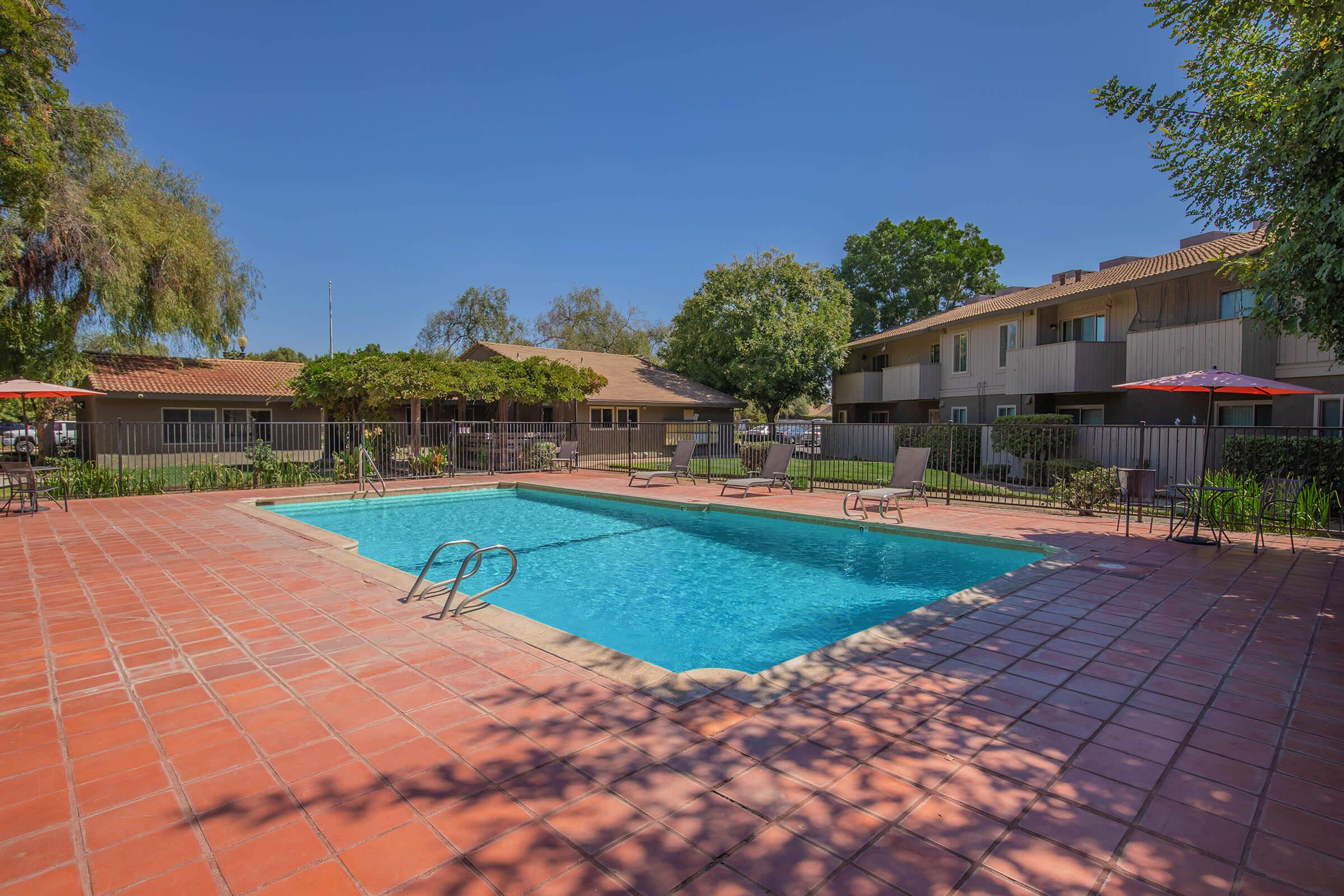 a house with a pool in front of a building