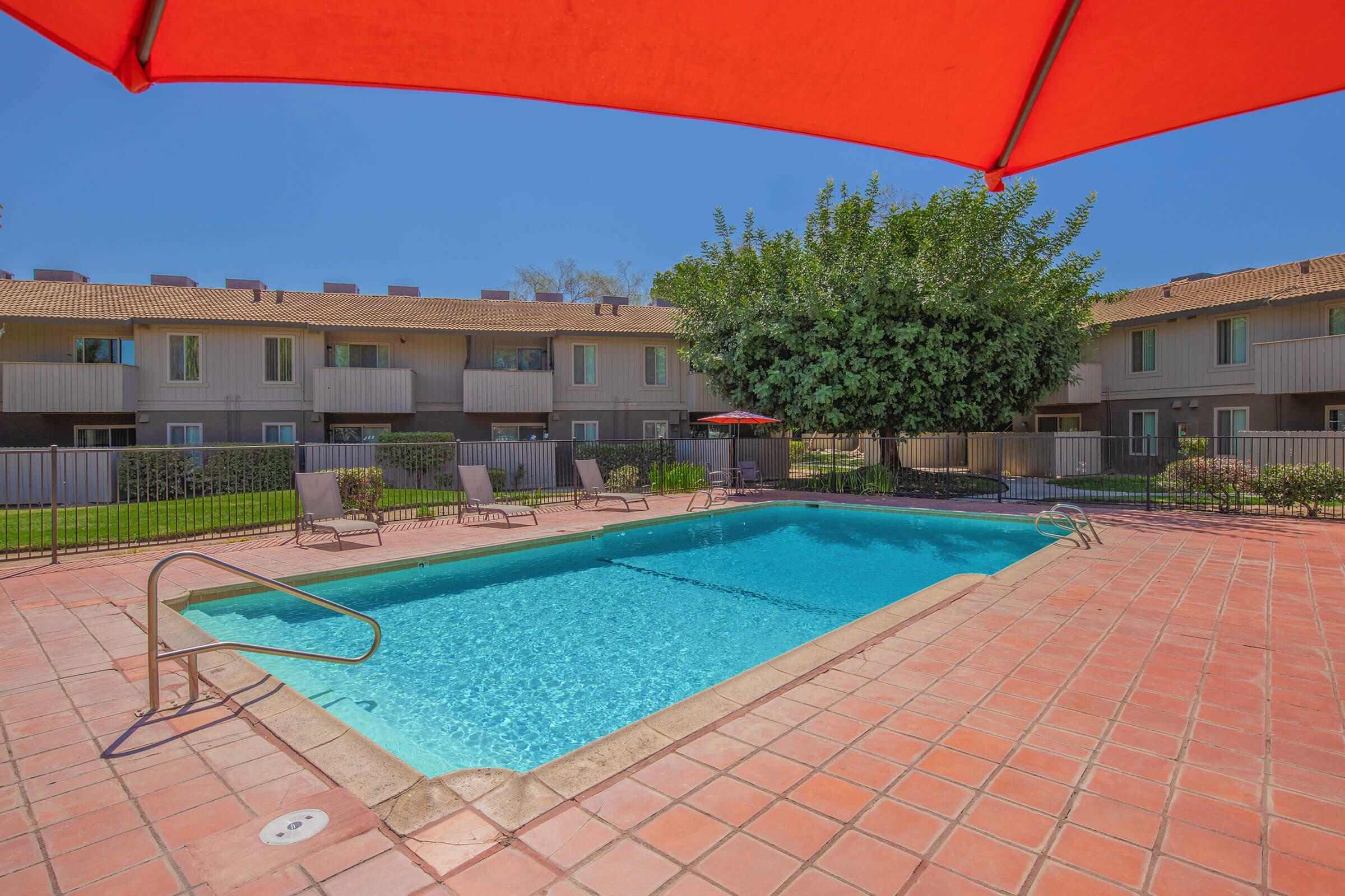 a large brick building with a blue umbrella