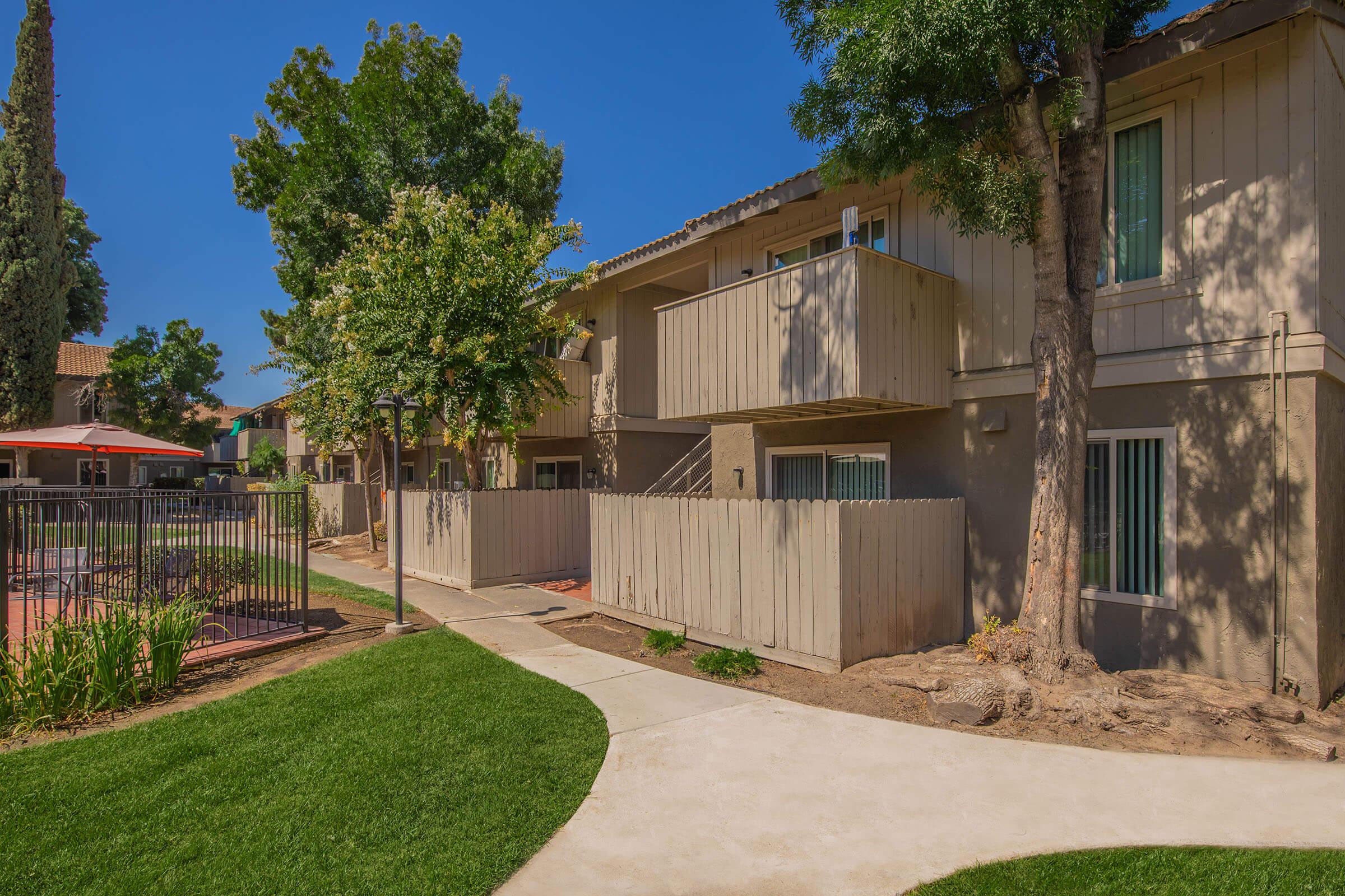 a house with a fence in front of a building