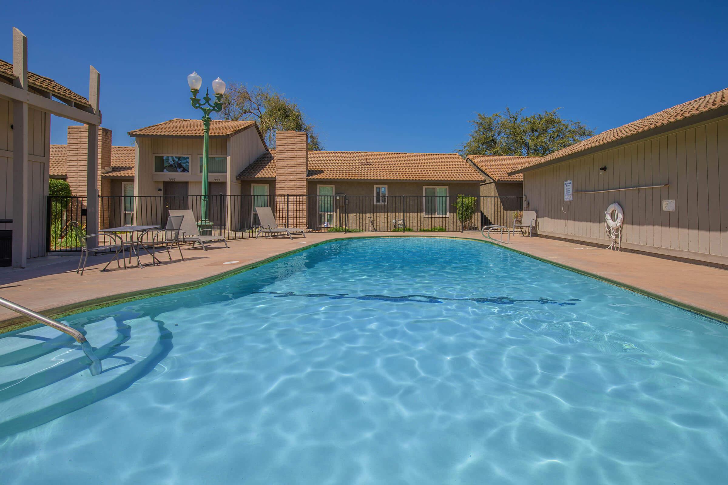 a house with a pool in front of a building