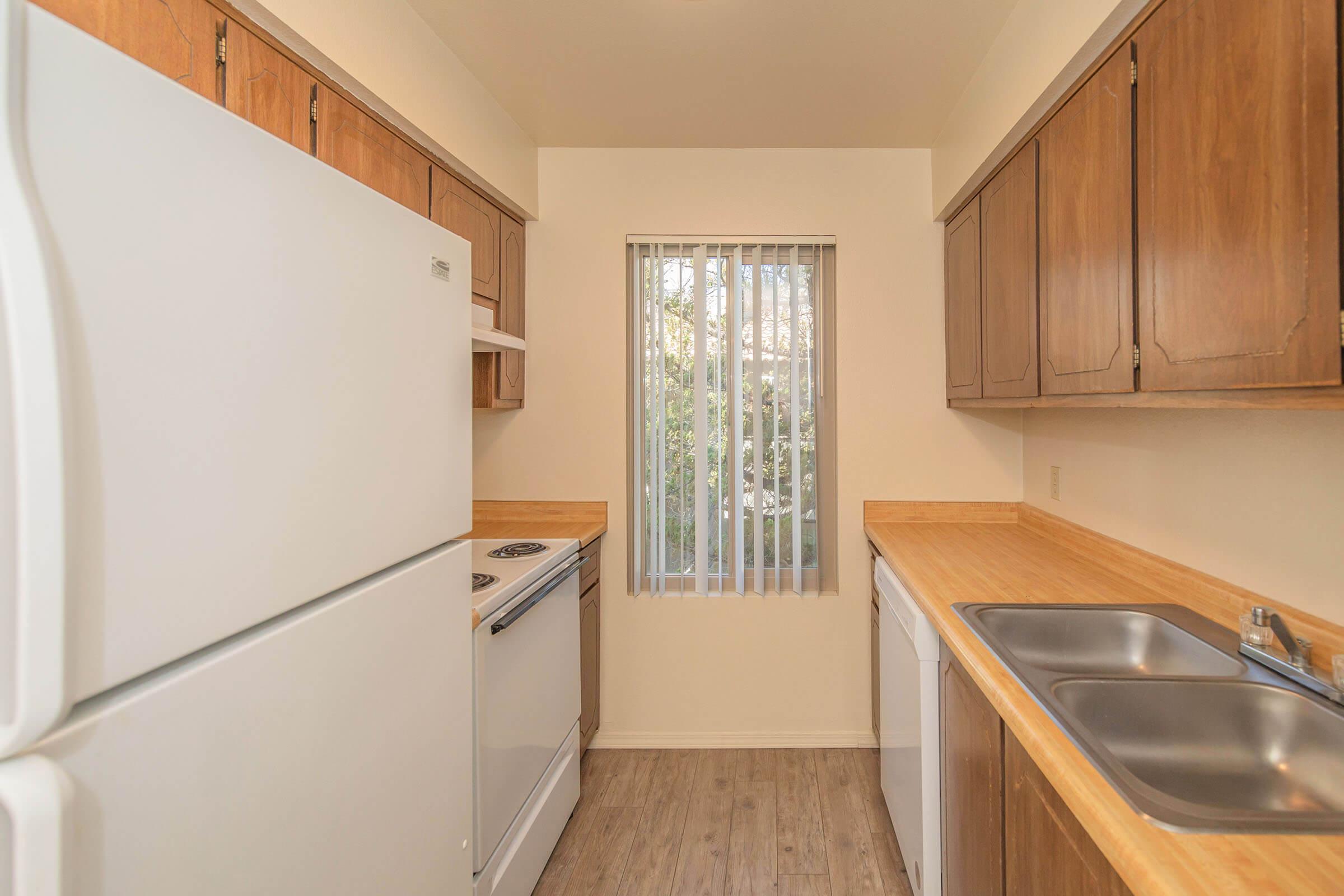 a kitchen with a stove and a refrigerator