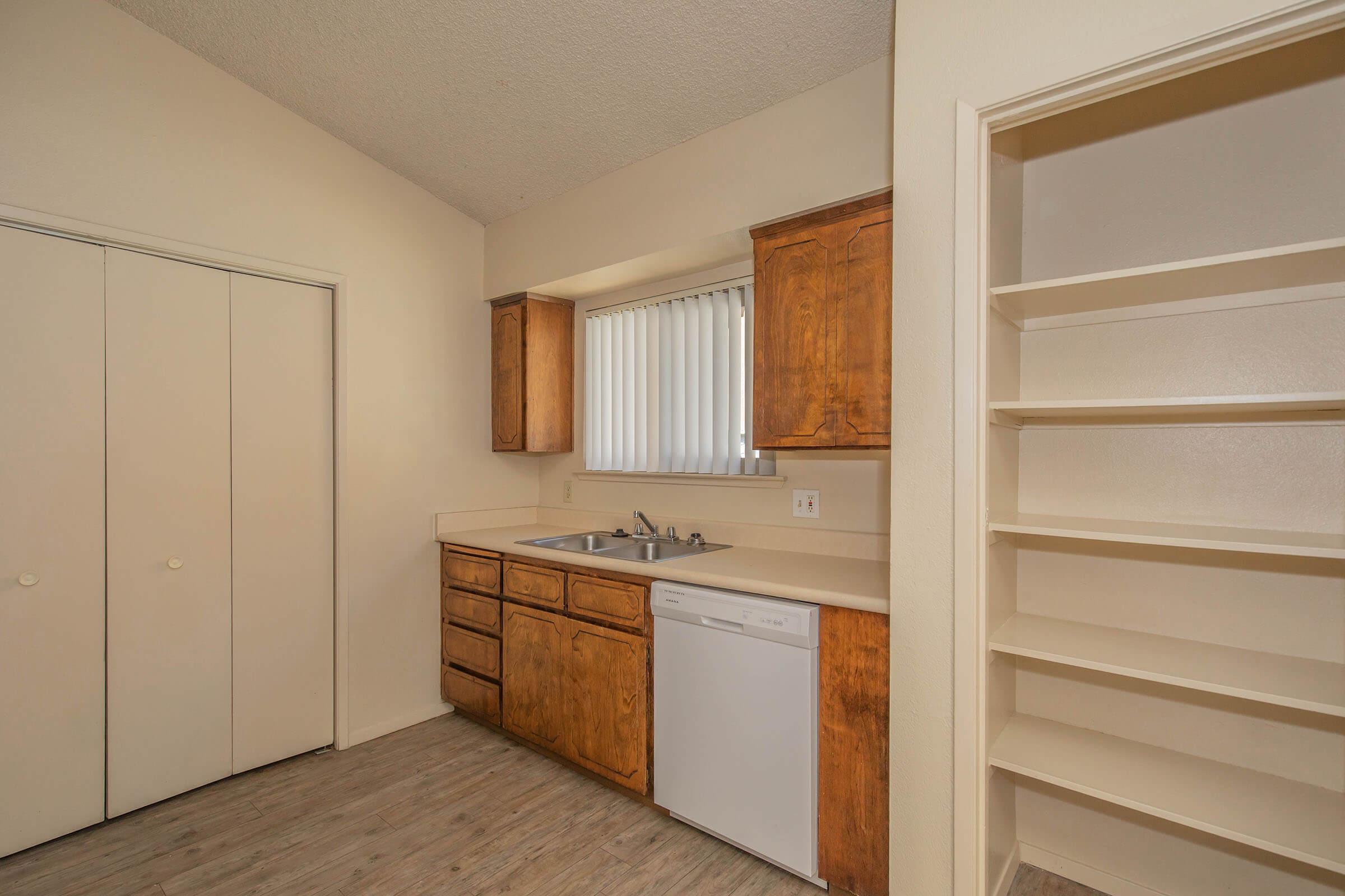 a kitchen with wooden cabinets