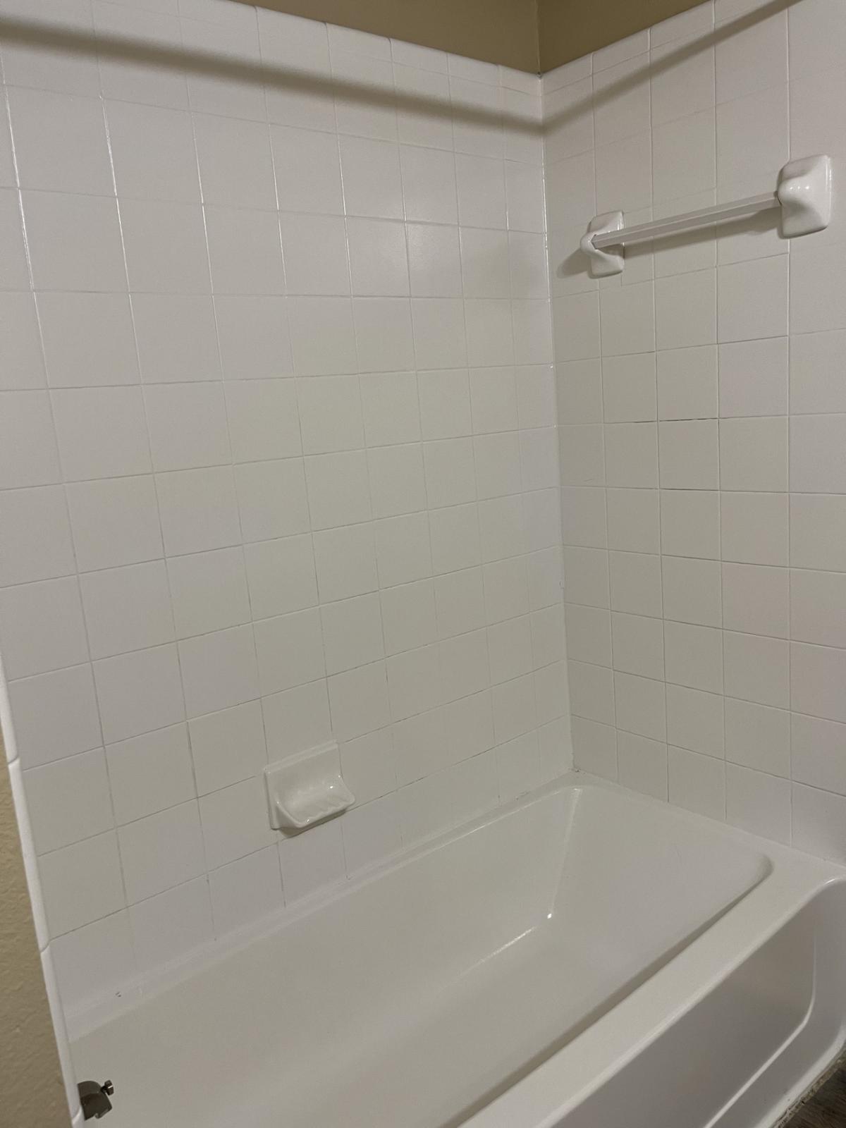 Experience the comfort of a pristine, spacious bathroom where relaxation meets modern convenience, perfect for unwinding after a long day.