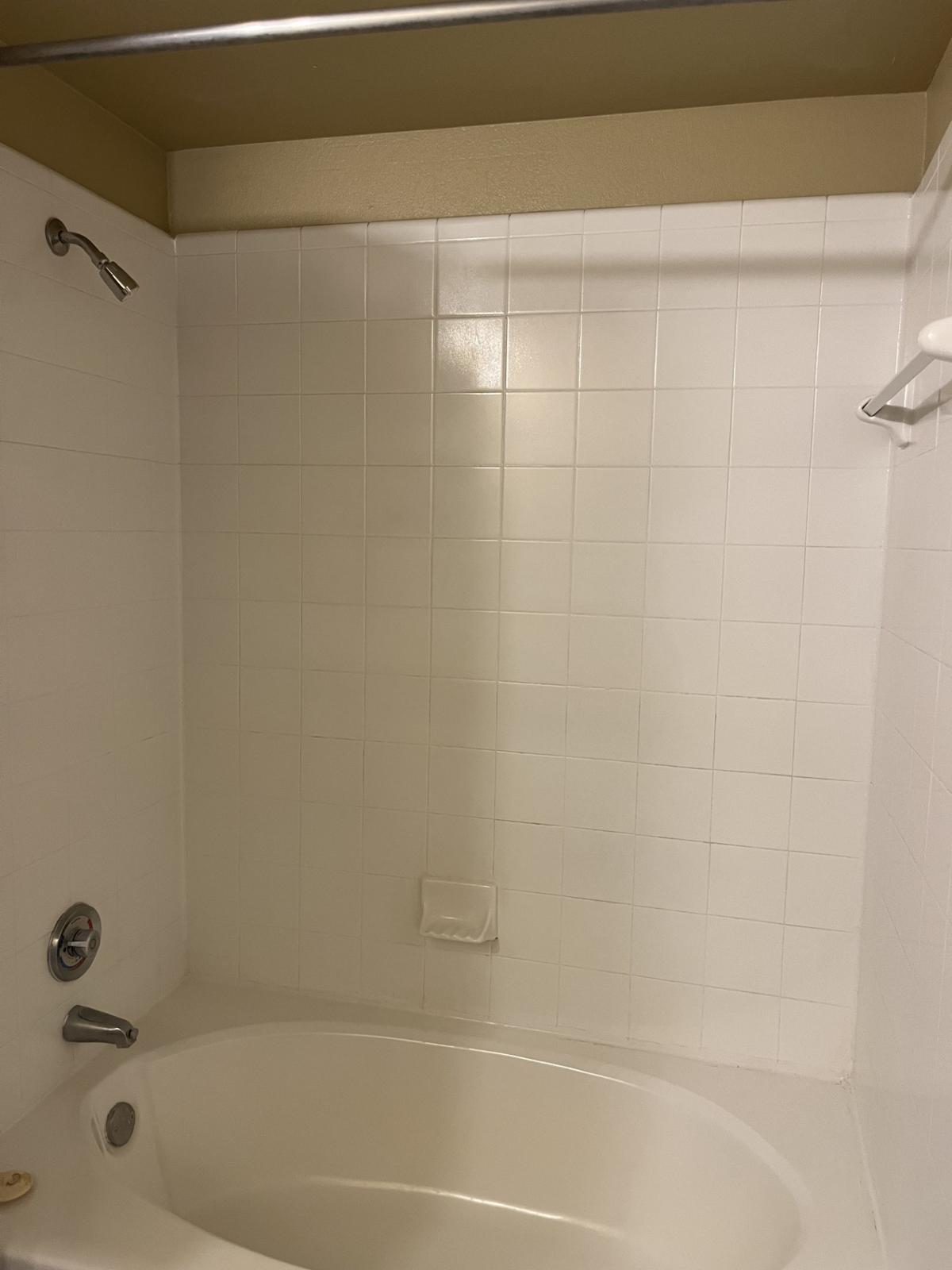 Unwind in this serene bathroom oasis, featuring a spacious soaking tub and pristine tile, perfect for relaxing after a long day.