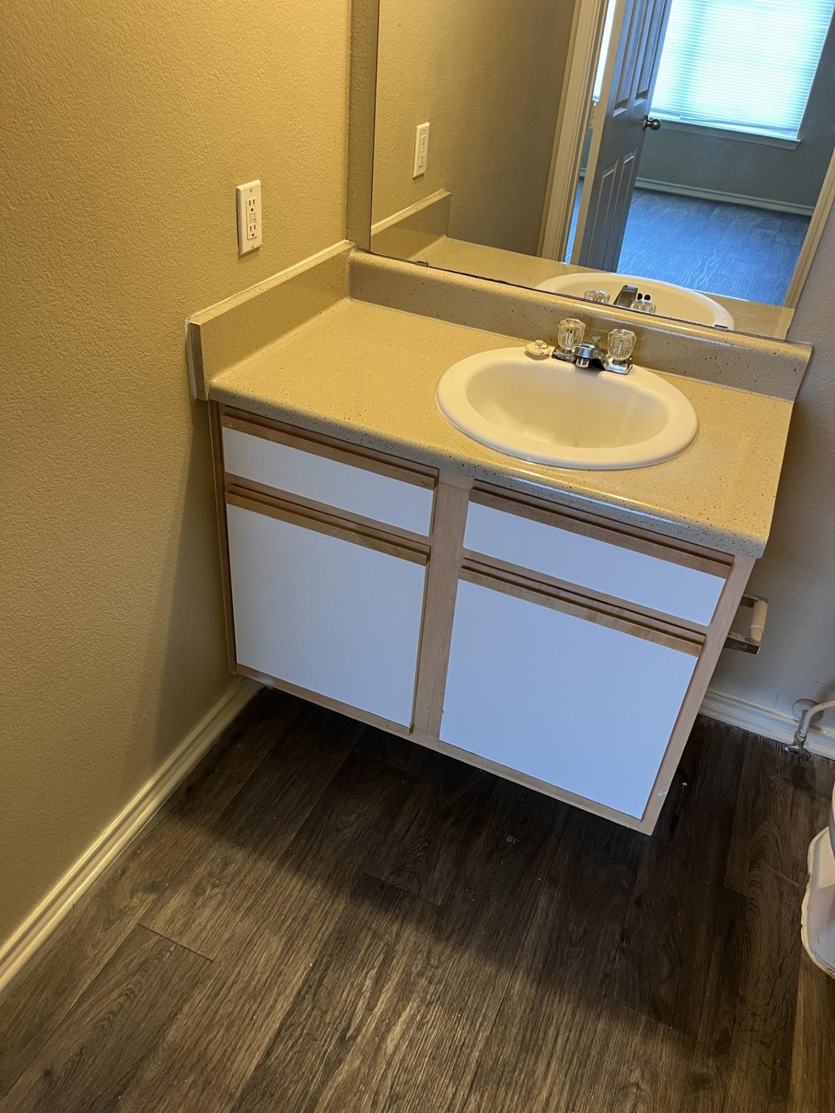 Discover a stylish and functional bathroom space that combines modern finishes with plenty of storage, creating a serene retreat in your new apartment.