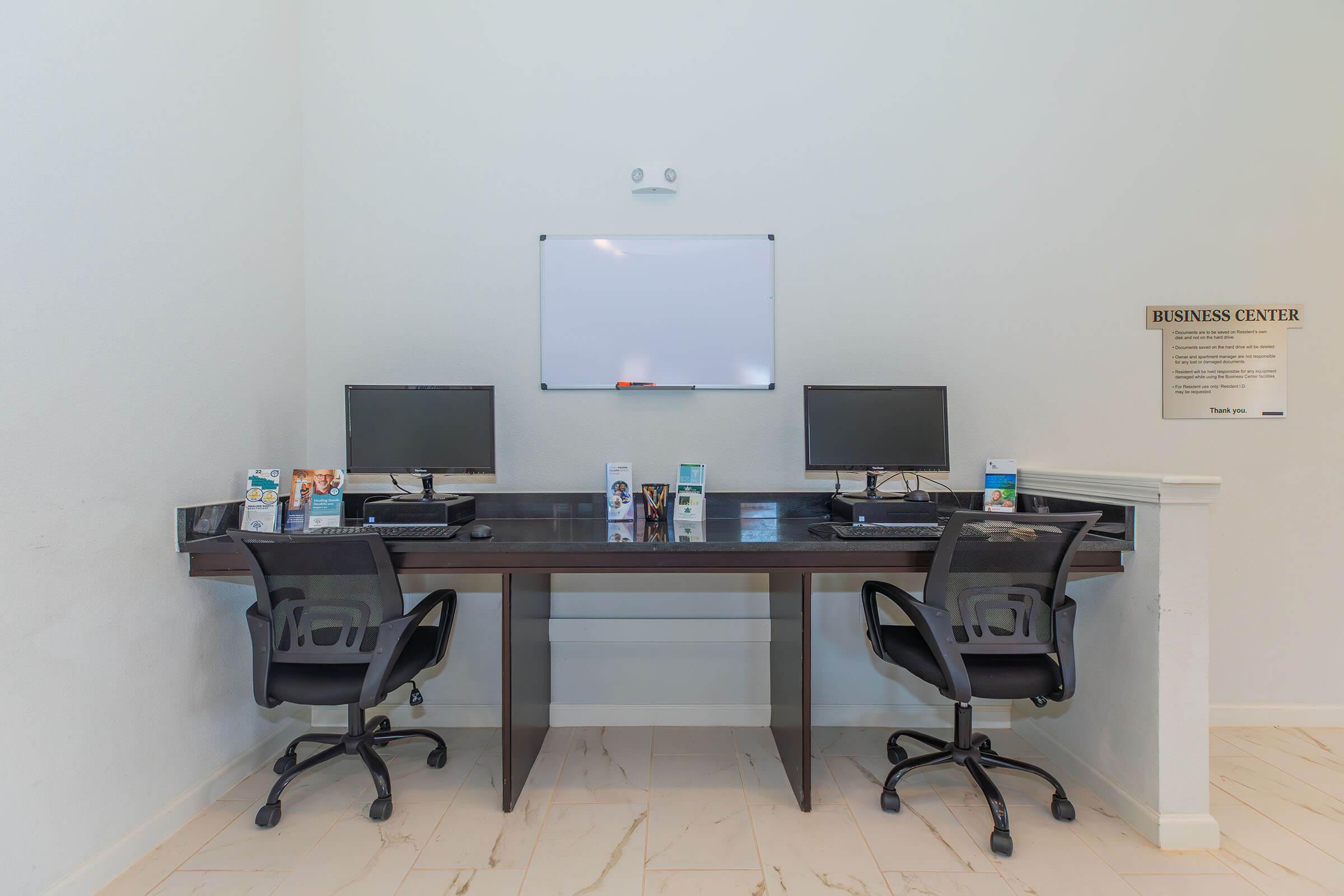 a desk with a computer in a room