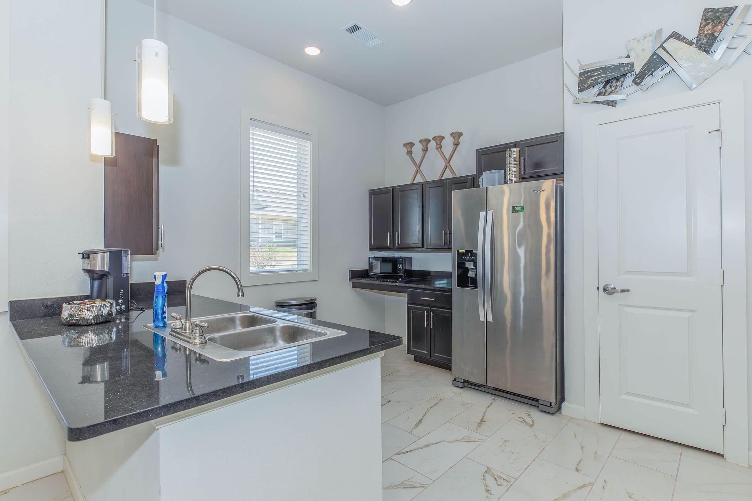 a kitchen with a sink and a refrigerator