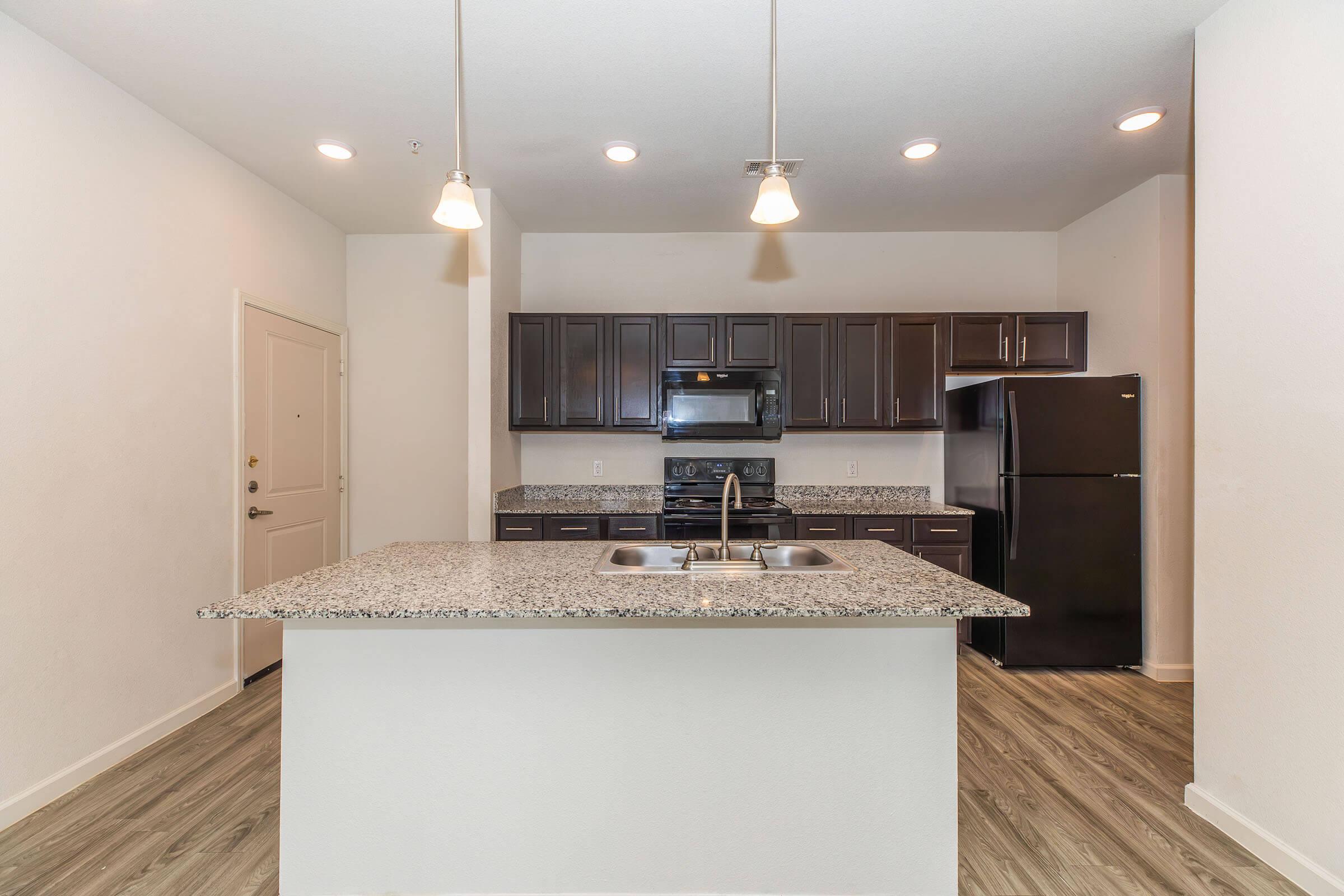 a modern kitchen with an island in the middle of a room