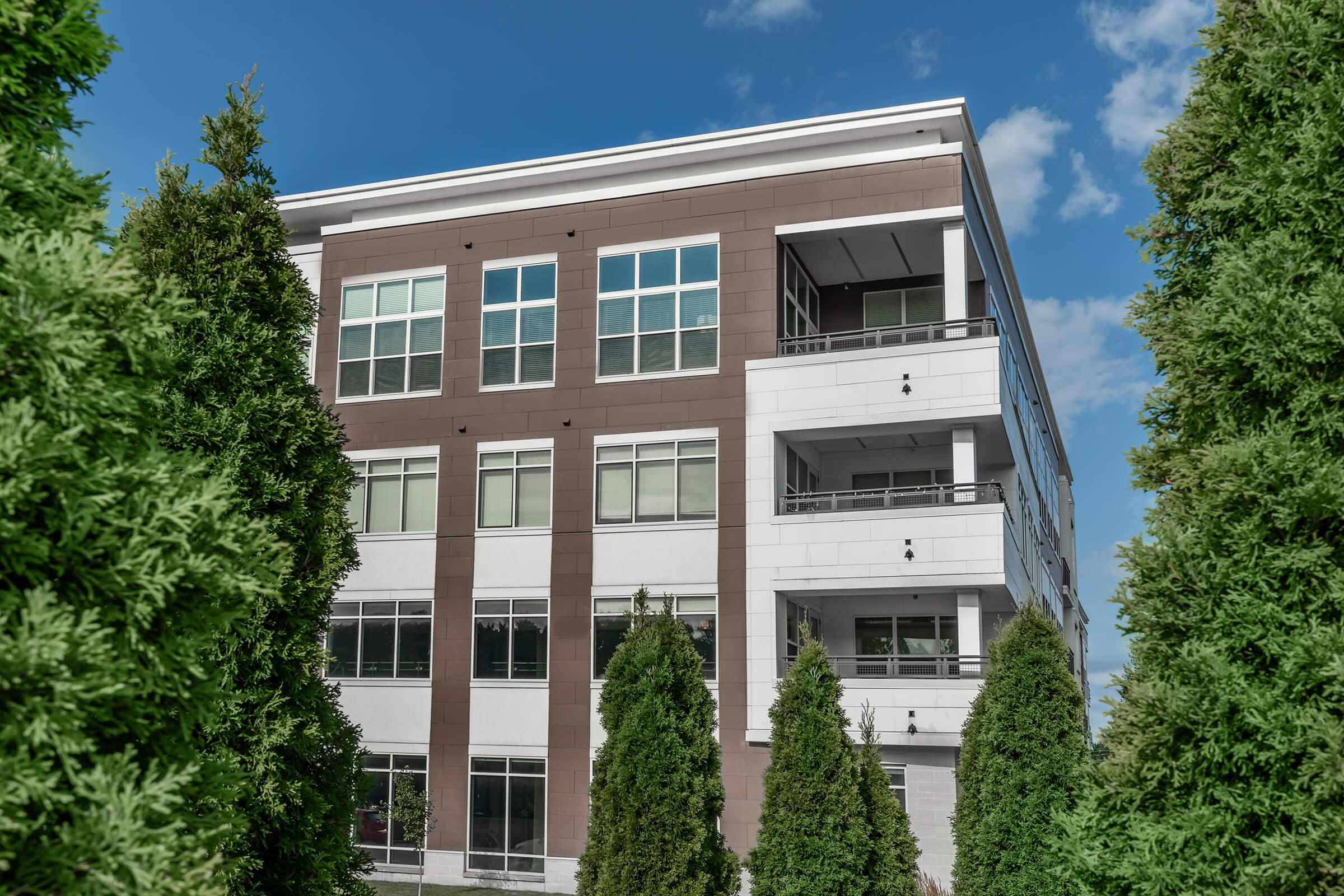 a house with bushes in front of a building