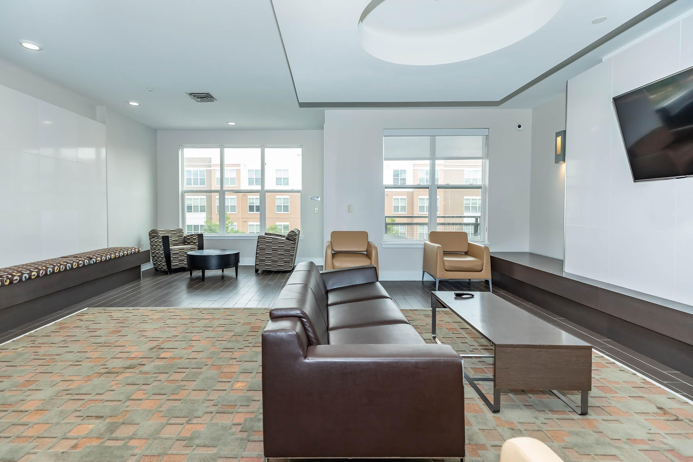 a living room filled with furniture and a large window