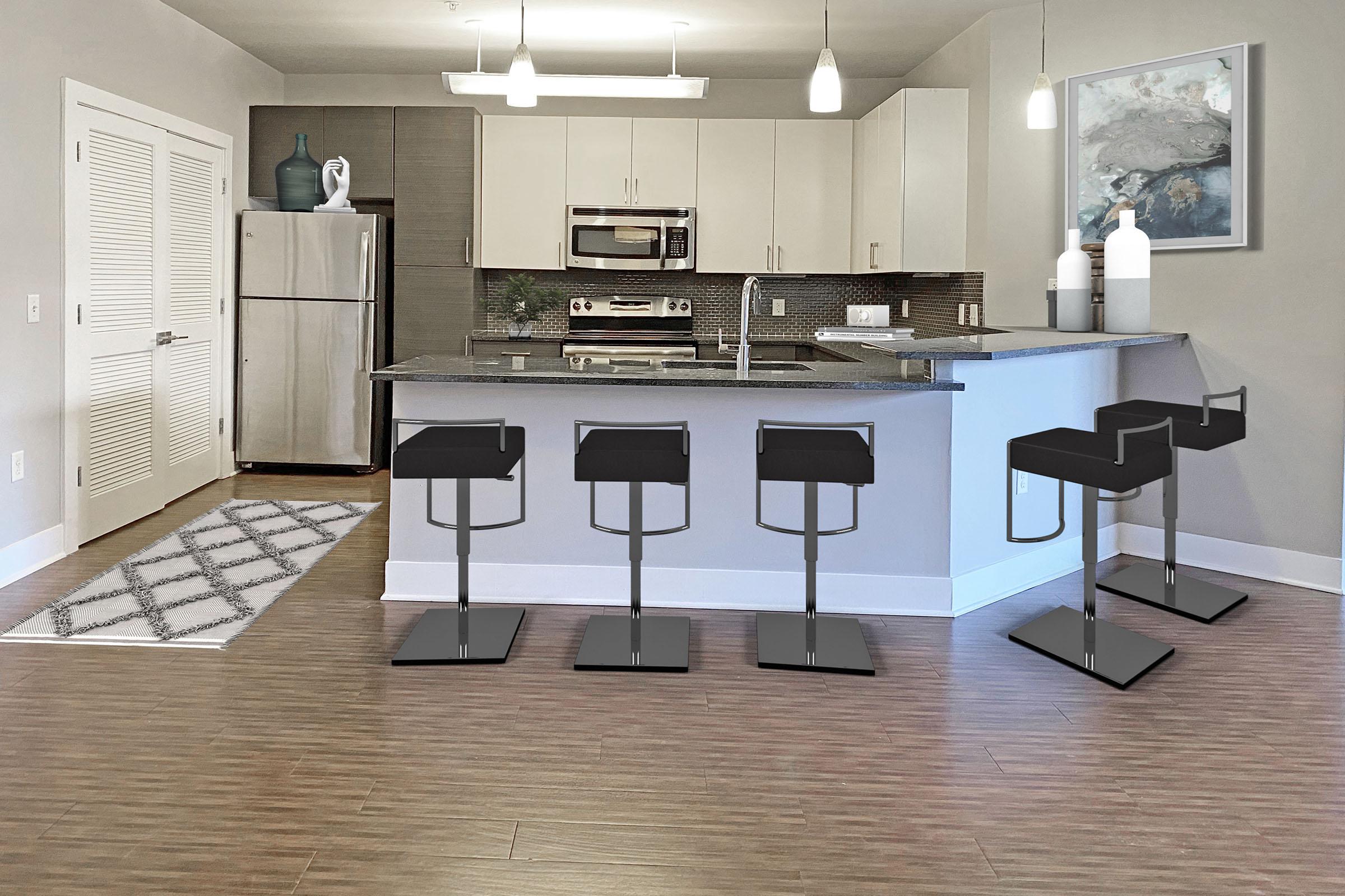 a kitchen area with a desk and chair in a room