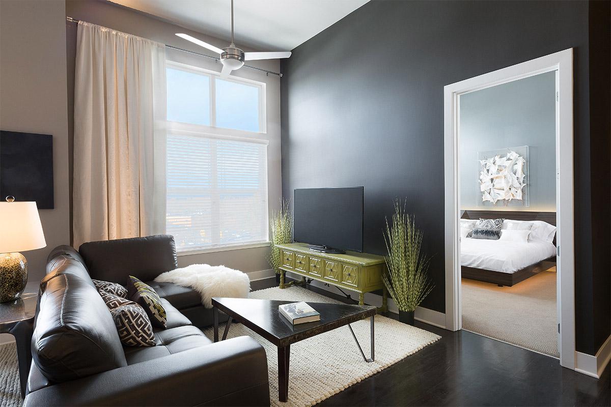 a living room filled with furniture and a large window