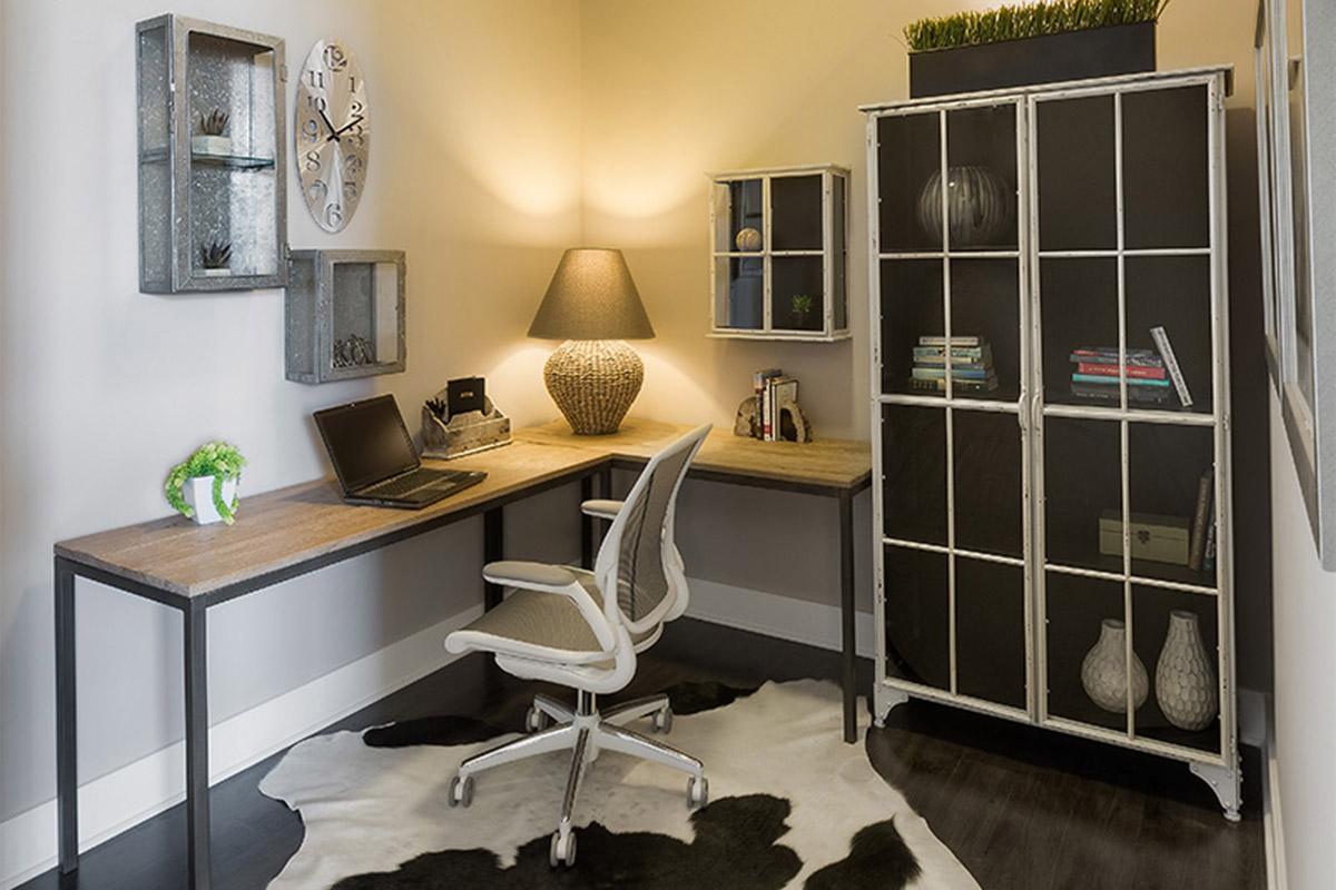 a desk with a computer in a room