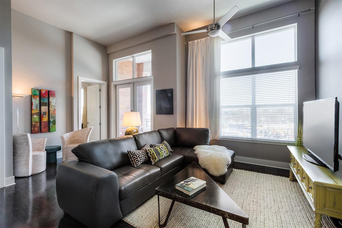 a living room filled with furniture and a large window