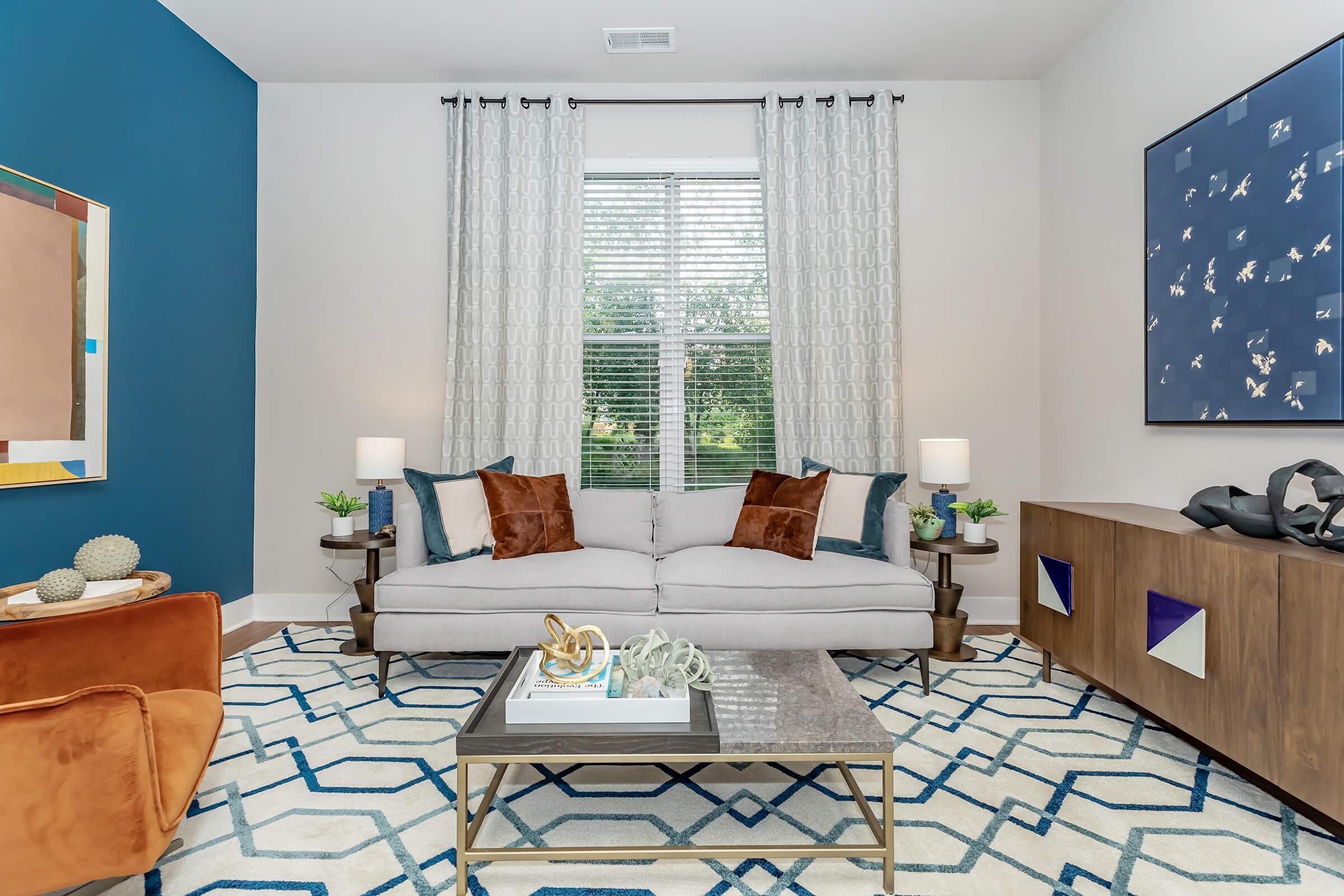 a living room filled with furniture and a large window