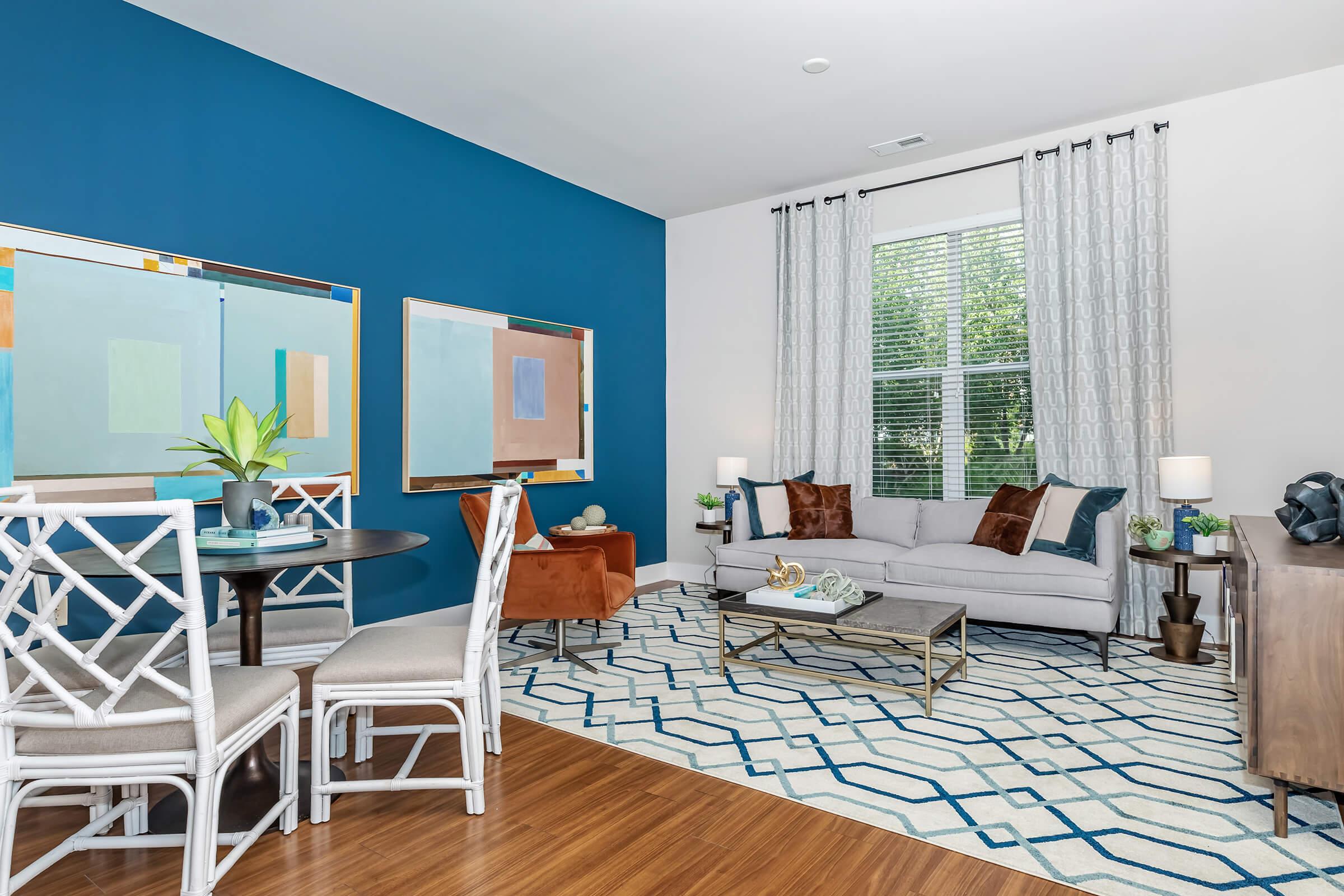 a living room filled with furniture and a large window