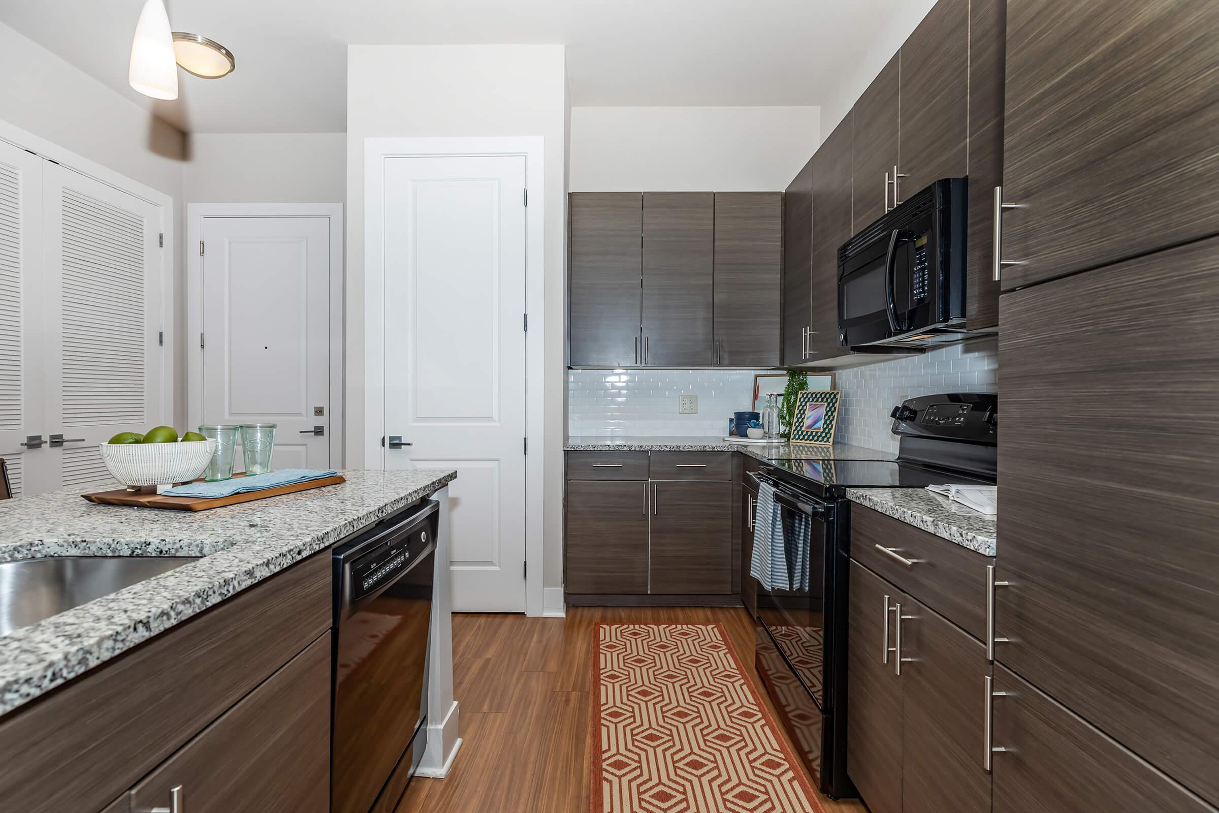 a modern kitchen with stainless steel appliances and wooden cabinets