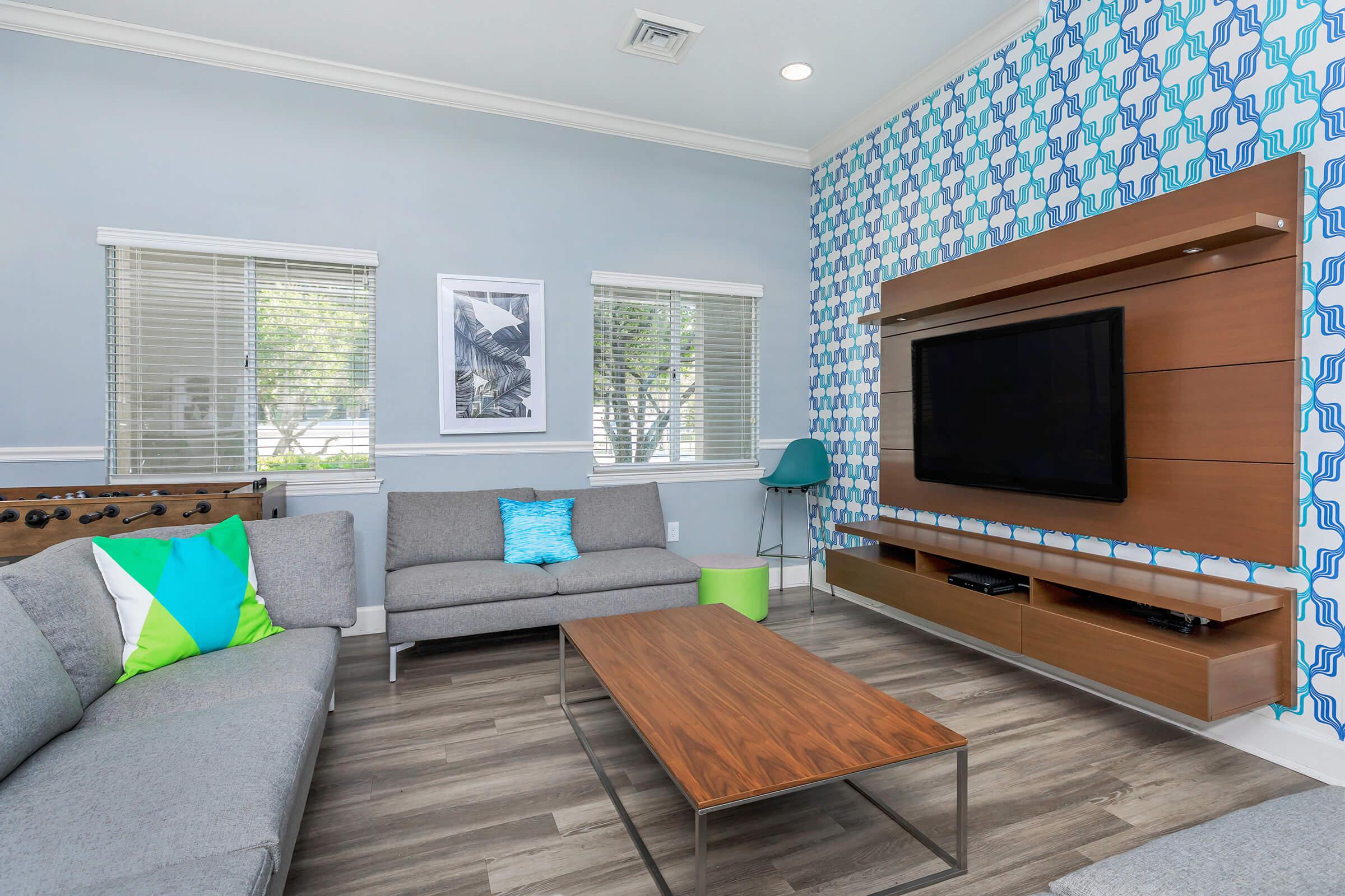 a living room filled with furniture and a flat screen tv