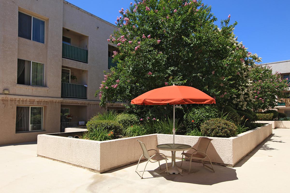 Courtyard with a table and red umbrella