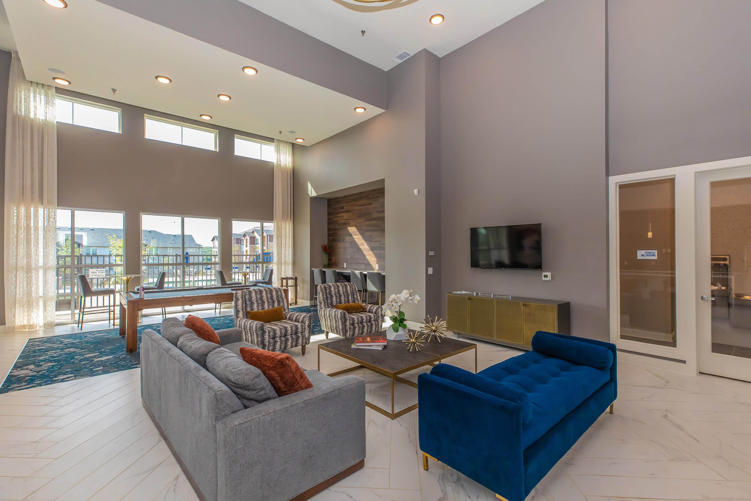 a living room filled with furniture and a large window