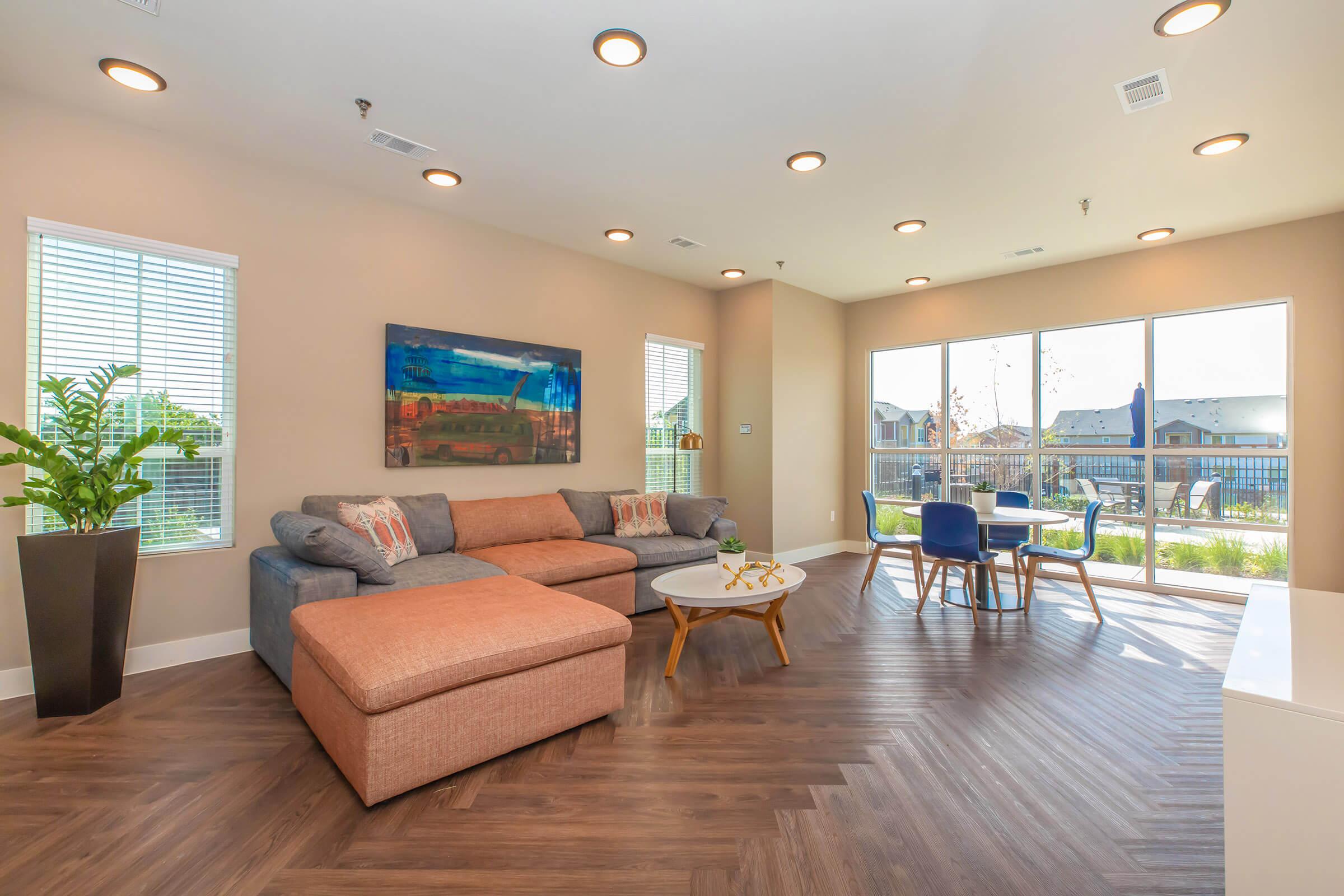 a living room filled with furniture and a large window