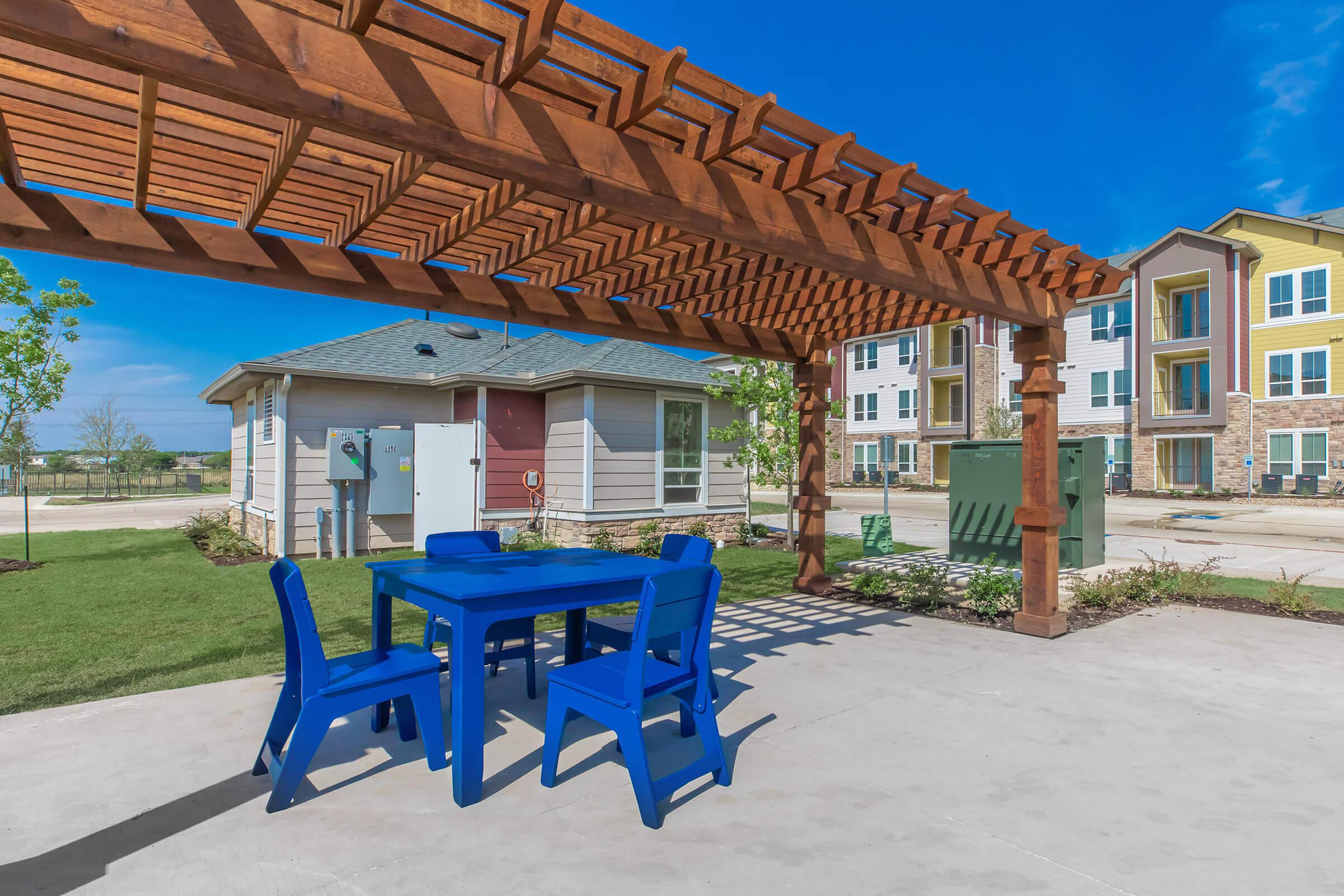 a blue bench in front of a building