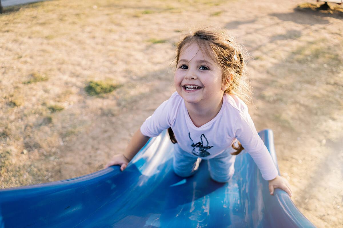 a little girl in a blue shirt