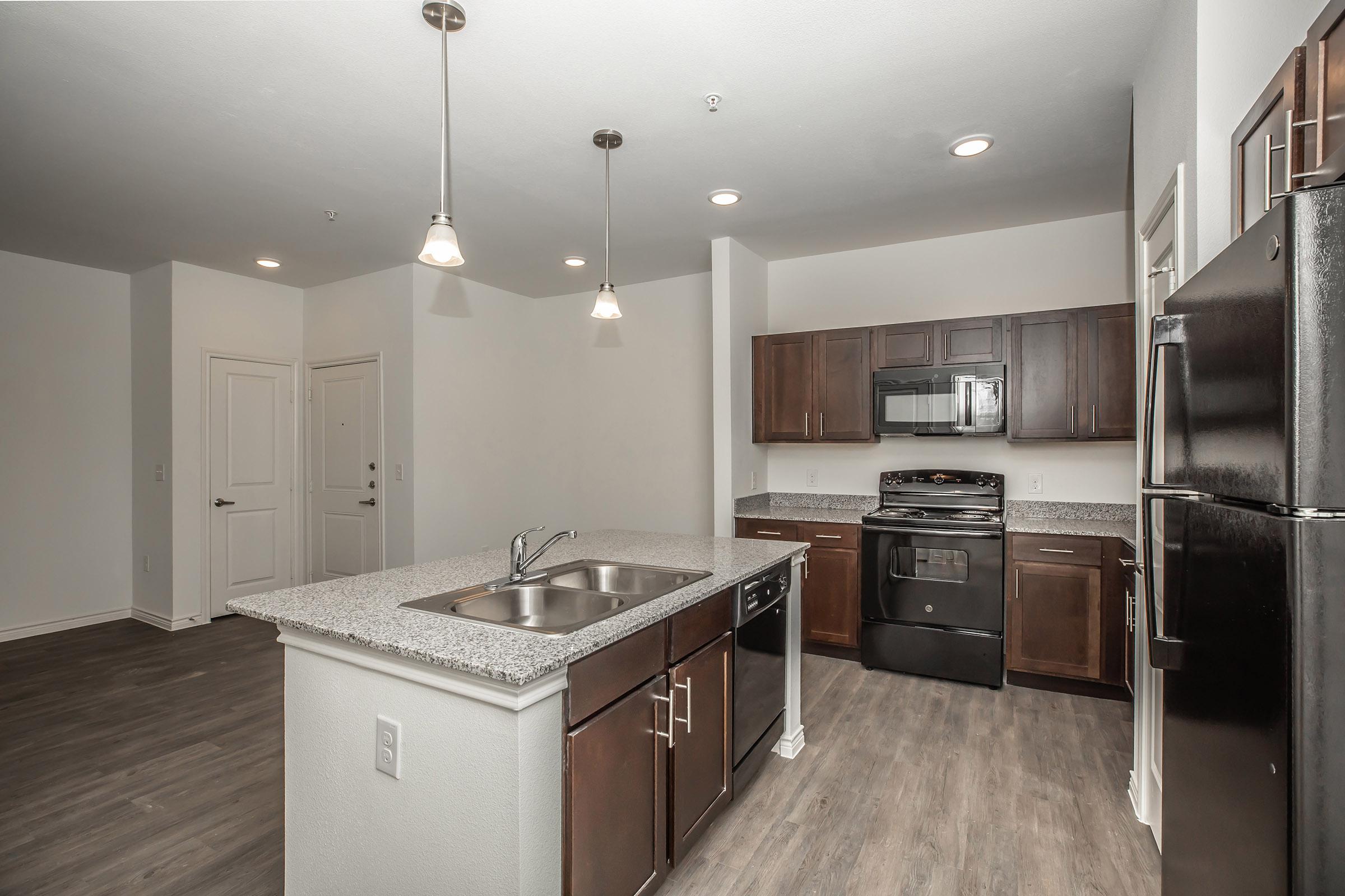 a large kitchen with stainless steel appliances