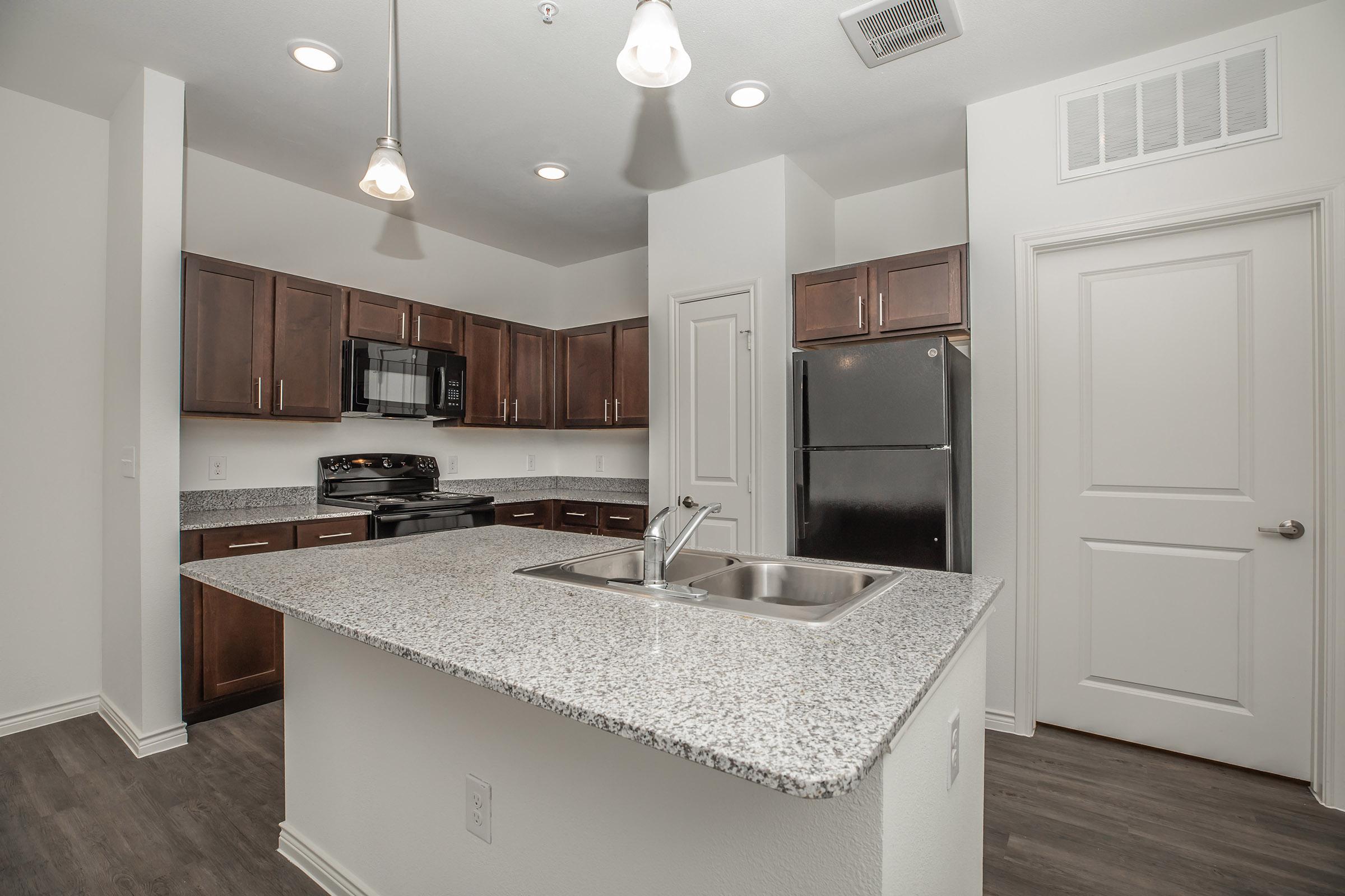 a kitchen with a sink and a mirror