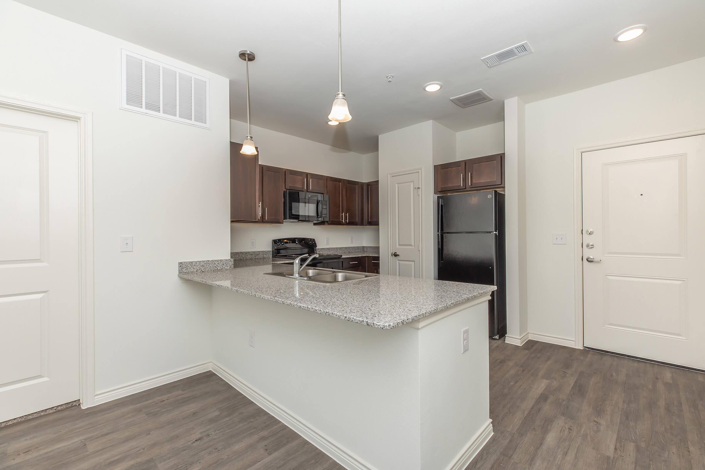 a kitchen with a sink and a refrigerator