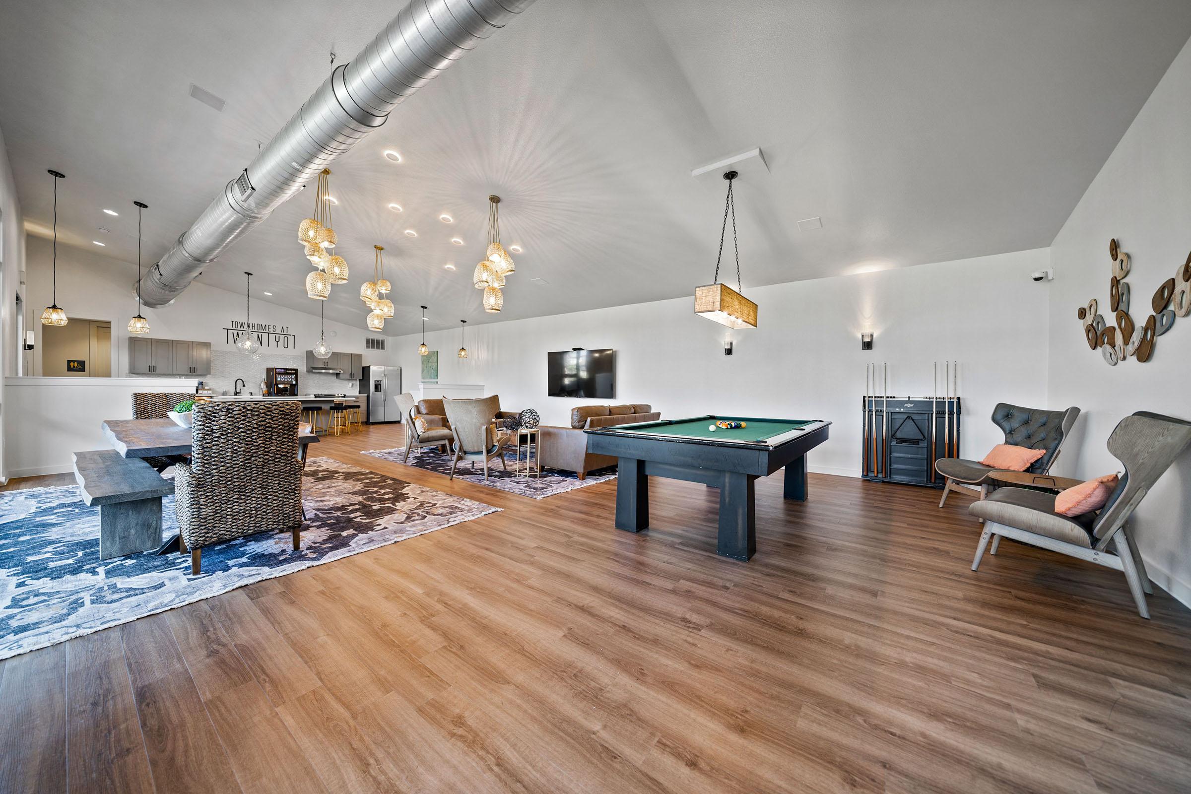 a group of people in a living room with a wood floor