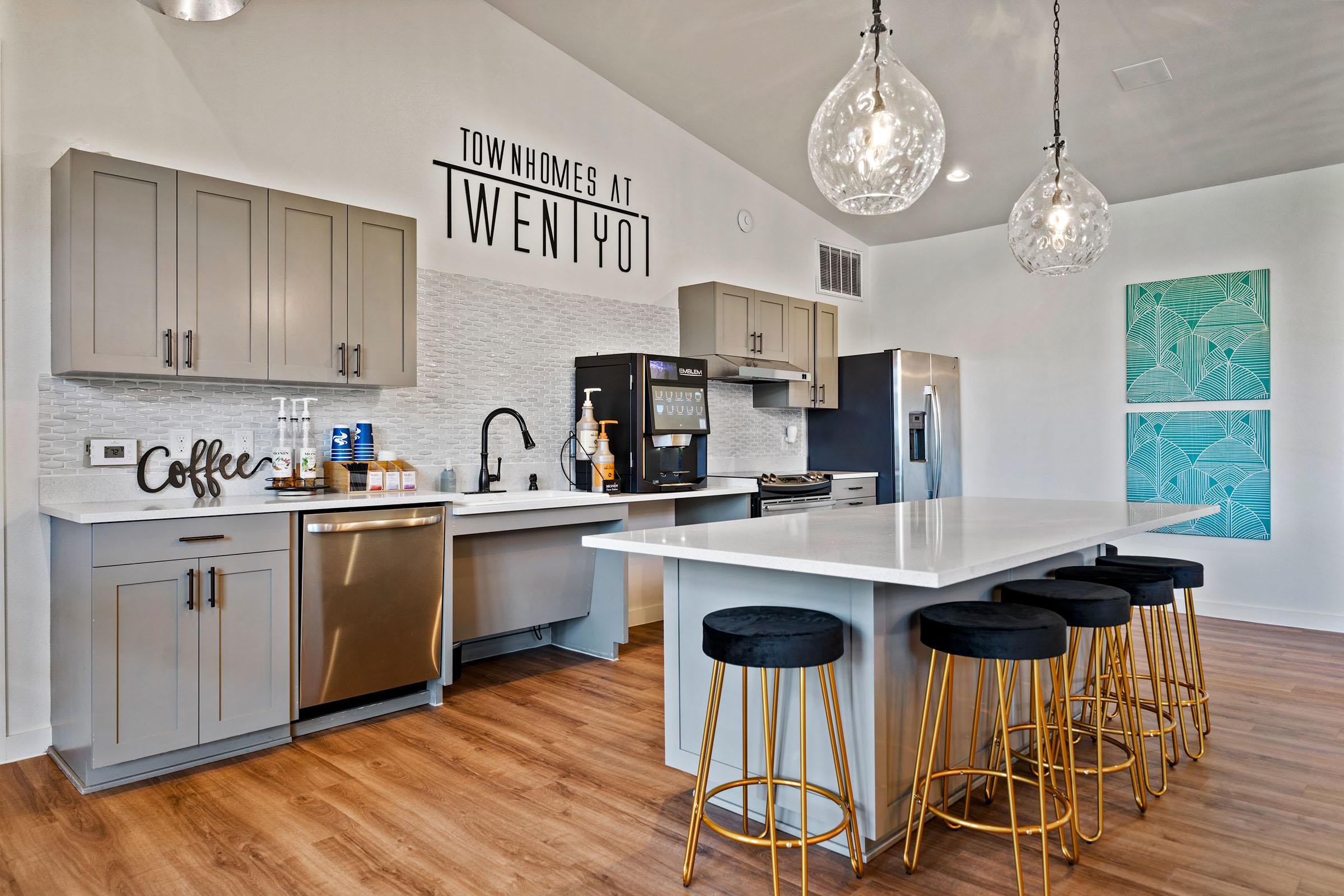 a kitchen area with a desk and chair in a room