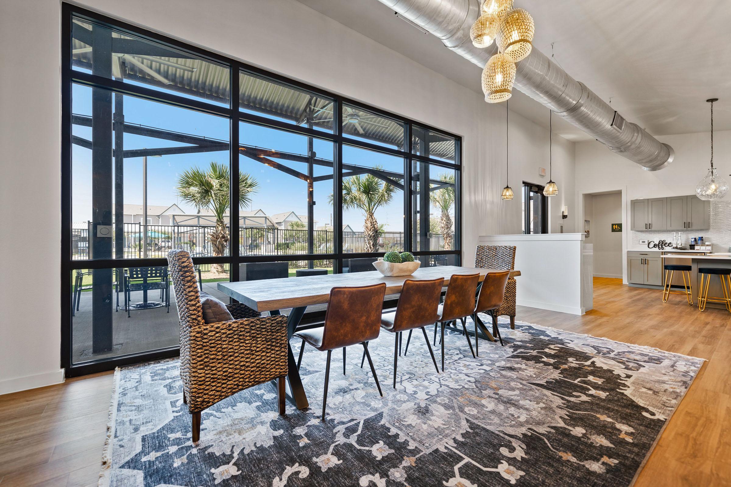 a living room filled with furniture and a large window