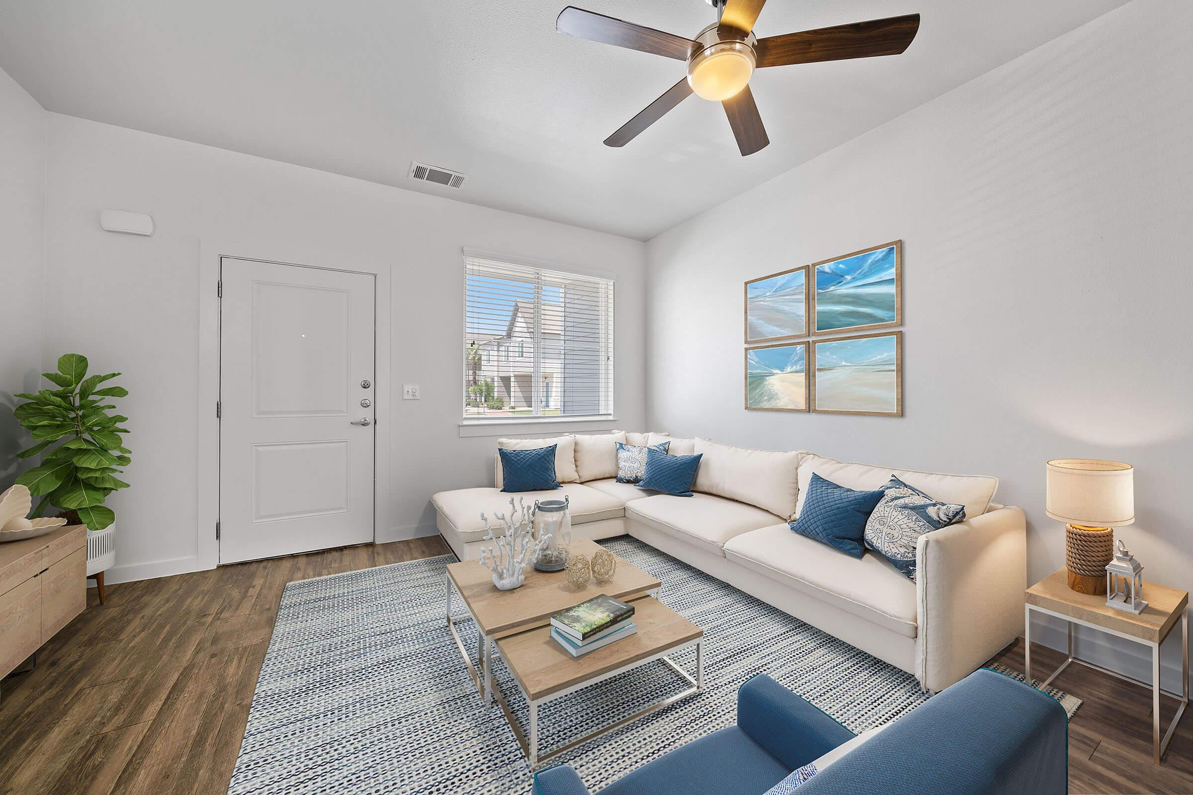 a living room filled with furniture and a large window