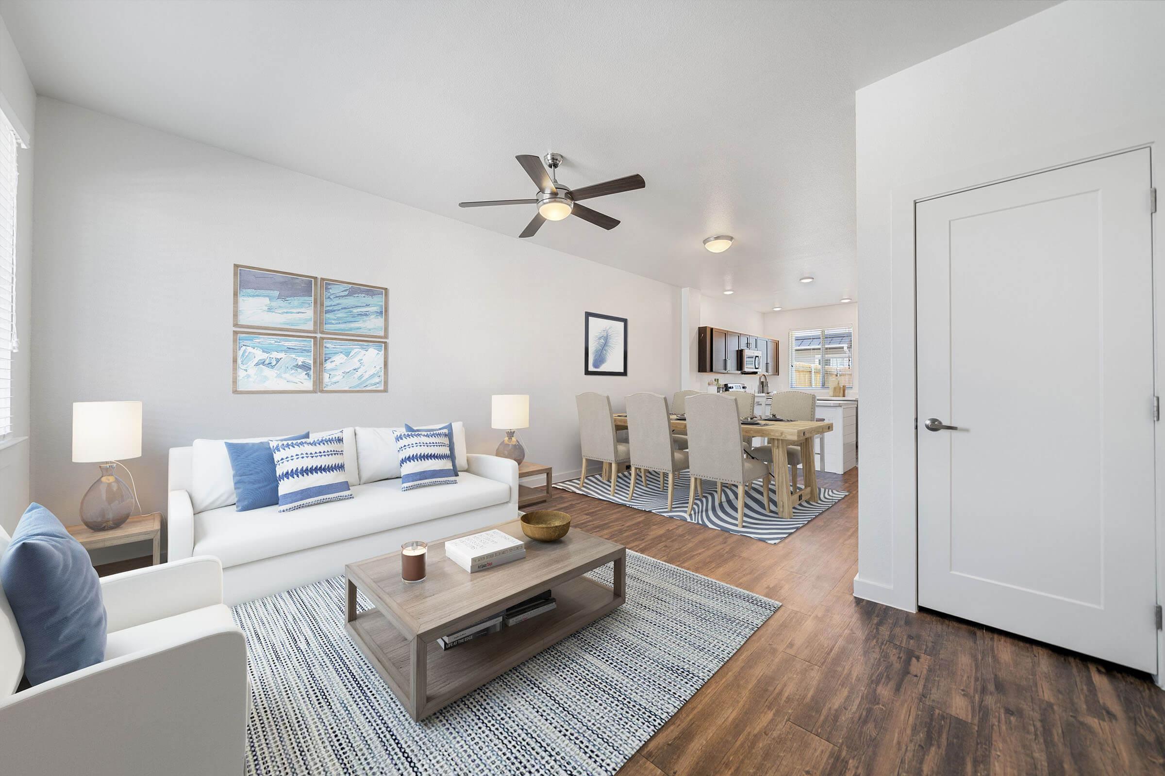 a living room filled with furniture and a refrigerator