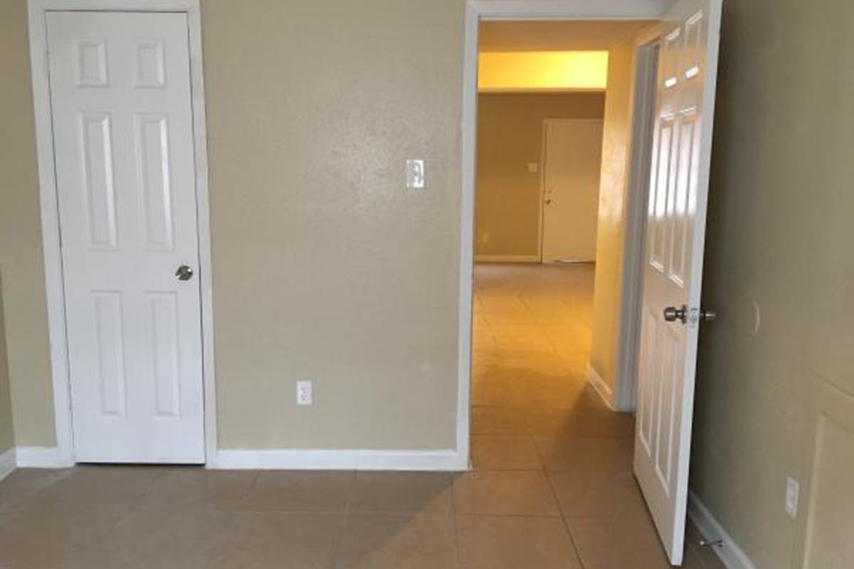 Bedroom and hallway with tile floors