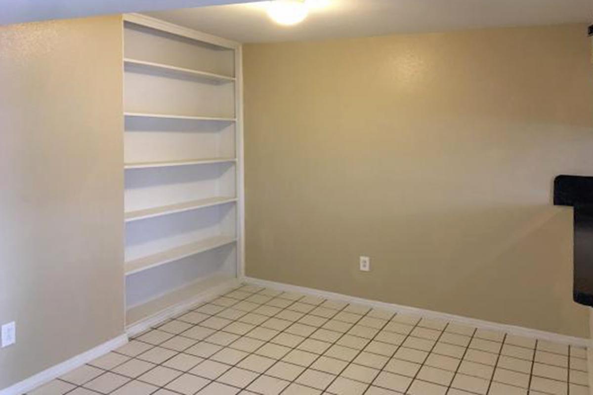 A room with built-in shelves 