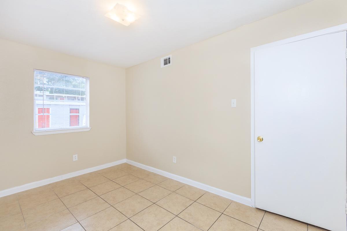 Unfurnished bedroom with tile floors