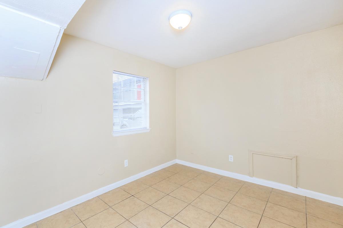 Vacant bedroom with tile floors