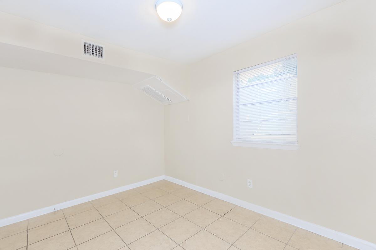 Vacant bedroom with open window blinds