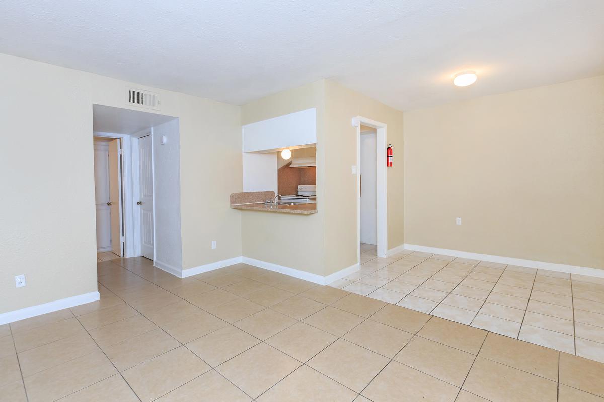 Unfurnished dining room and living room with tile floors