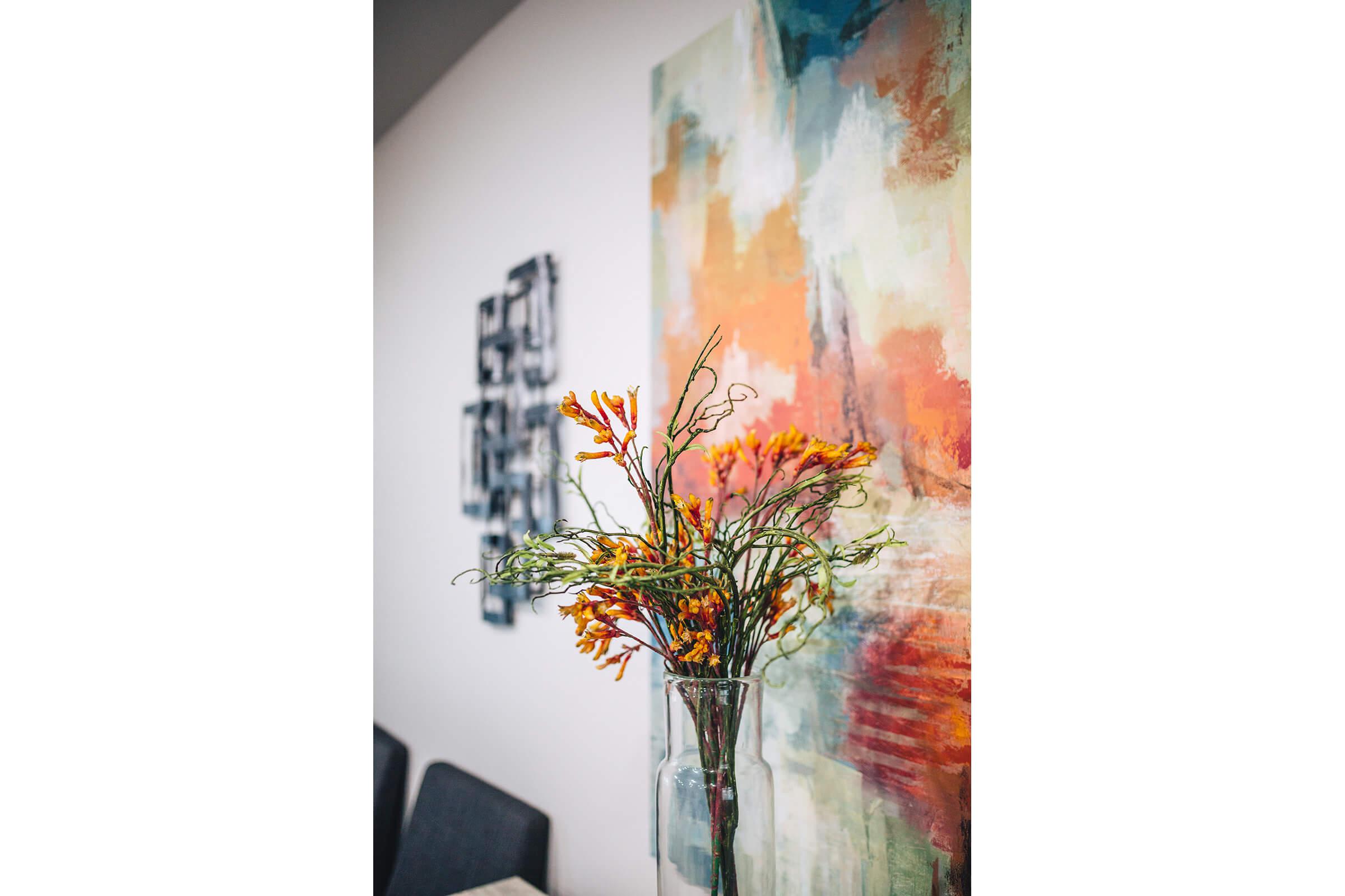 orange flowers in front of a painting