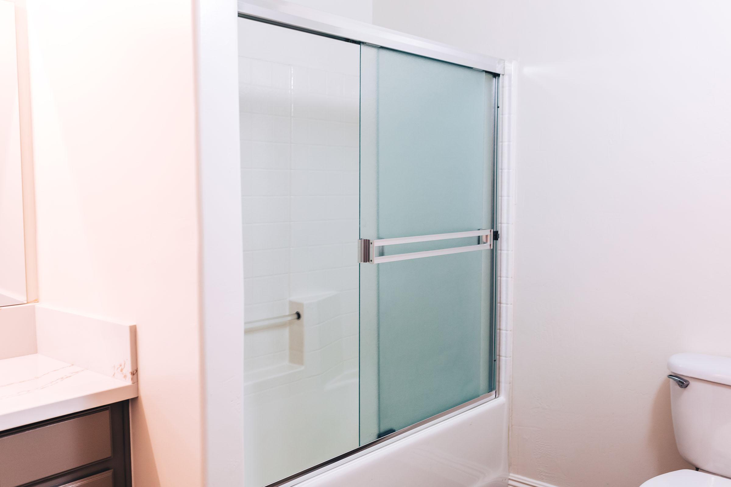 bathroom shower with glass sliding doors